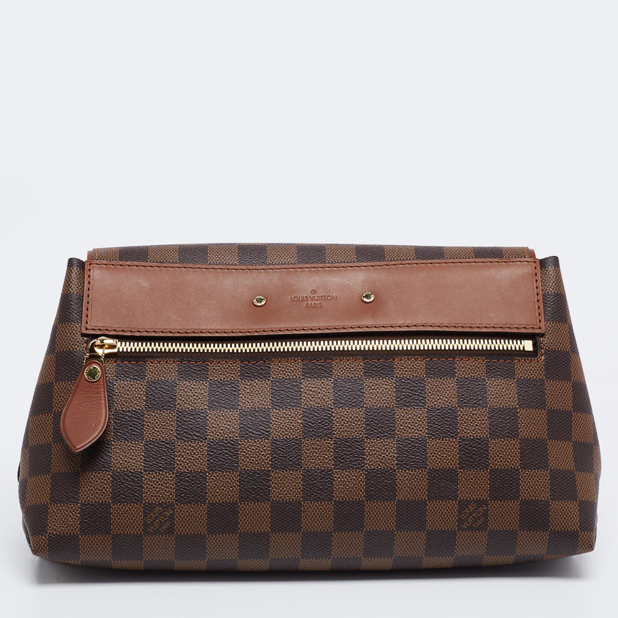 The house of Louis Vuitton brings you the perfect everyday clutch! Crafted skillfully from coated canvas, the brown piece is adorned with gold-tone details and has a front flap that opens into a well-sized interior. It is finished with a zip pocket