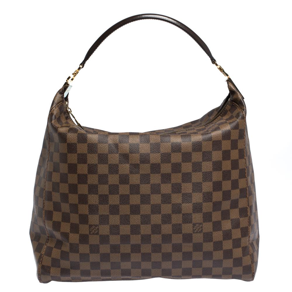 Elevate your look with this well crafted Louis Vuitton Portobello bag. Crafted from signature Damier Ebene canvas, the bag comes with a top handle. The zipper pull opens to an Alcantara lined interior that has enough space to store your essentials.