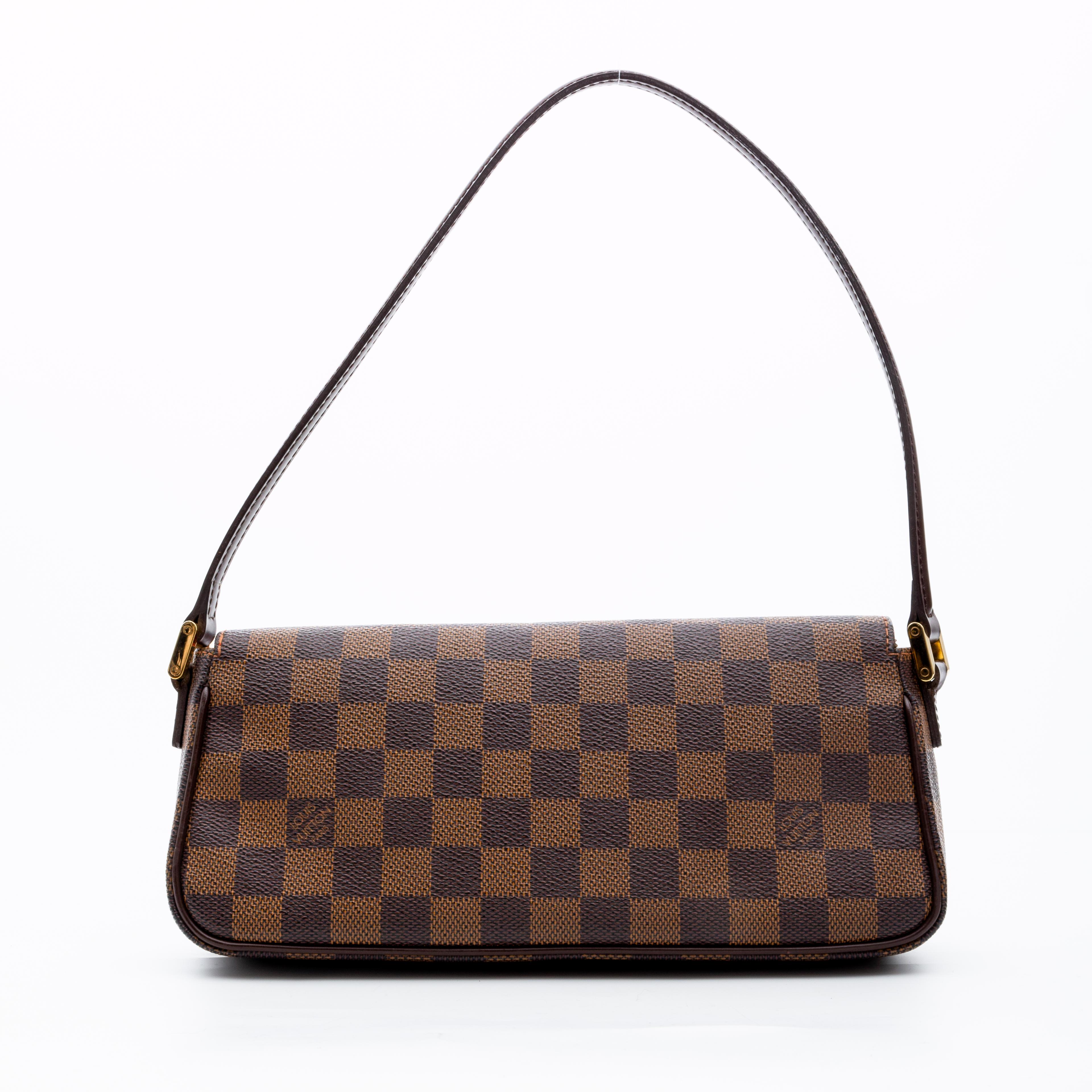 This bag is made with brown Damier ebene coated canvas. The bag features brown leather trim, a flat leather shoulder strap, gold tone hardware, a front flap with snap closure and an interior with red alcantara lining with a patch pocket. (Damier