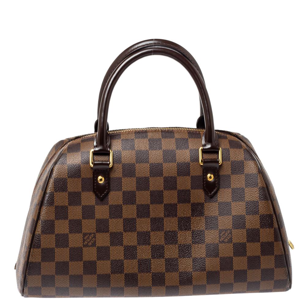 Louis Vuitton’s Ribera MM bag will become your favorite bag in no time. Crafted from signature Damier Ebene canvas, it features dual-rolled top handles and a wrap-around zip closure that opens to a canvas-lined interior that houses a cell-phone