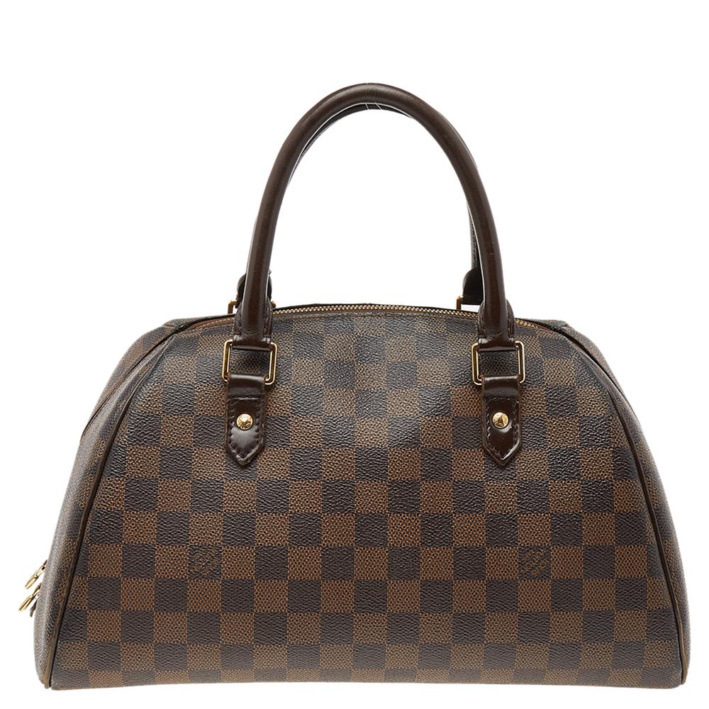 Louis Vuitton’s Ribera MM bag will become your favorite bag in no time. Crafted from signature Damier Ebene canvas, it features dual-rolled top handles and a zip-around closure that opens to a spacious canvas-lined interior.