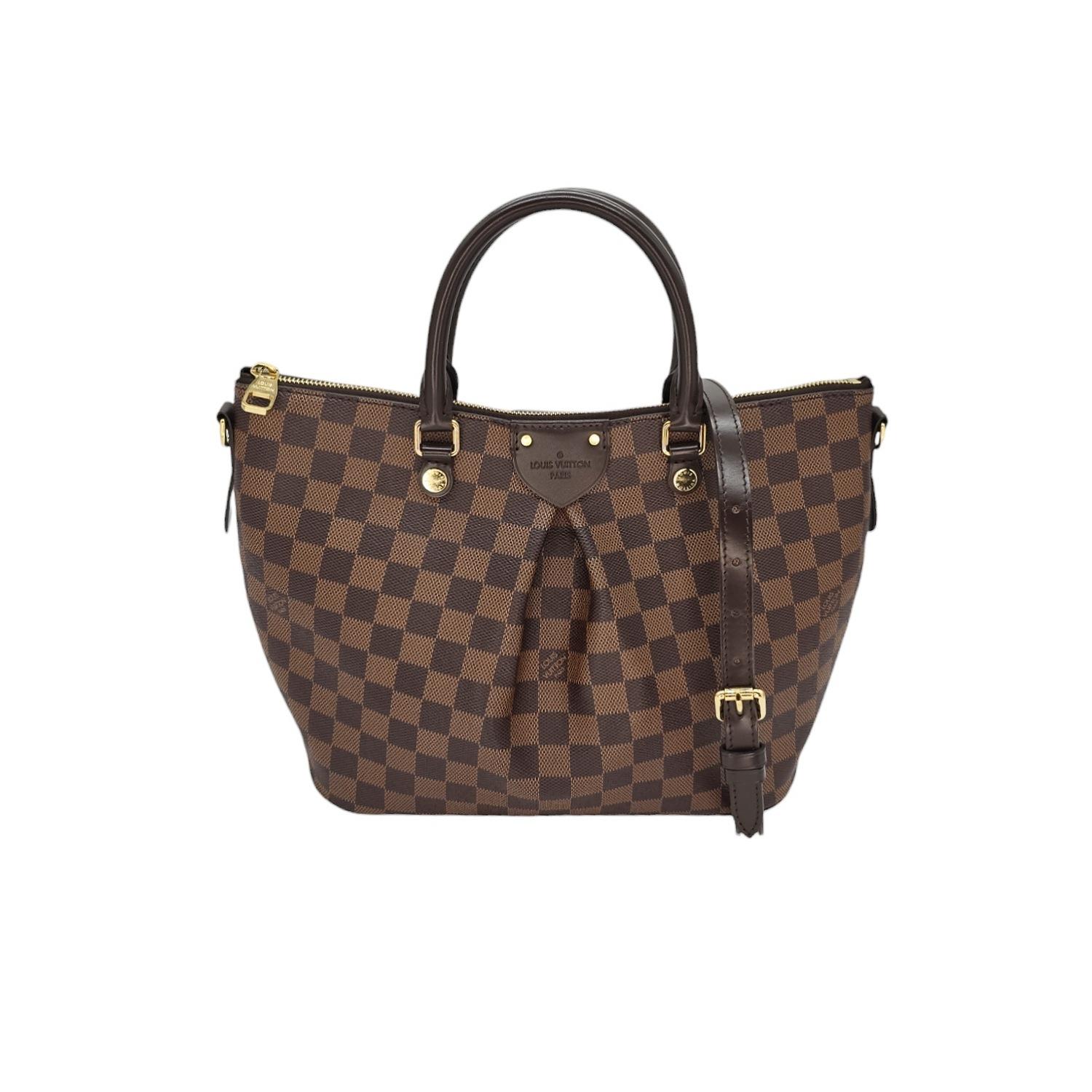 Expertly crafted in Damier Ebene check canvas, the Louis Vuitton Siena tote features a prominent pleat for added style. The rolled leather handles and adjustable shoulder strap offer versatility, while the scarlet fabric interior and patch pockets