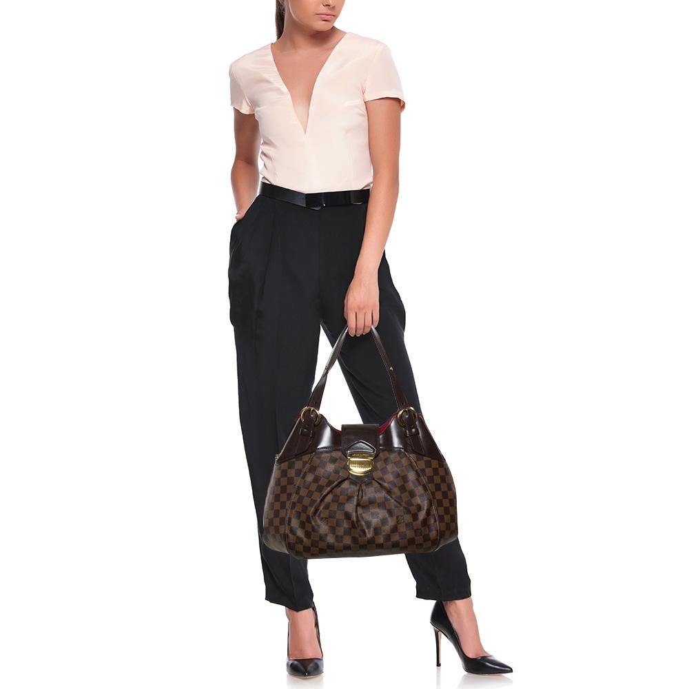 Louis Vuitton's handbags are famous for their high style, durability, and functionality. This Sistina bag, like all the other designs, is practical and stylish. Crafted from Damier Ebene canvas, the bag can be paraded using dual handles. It is