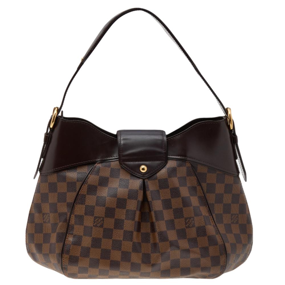 Louis Vuitton's handbags are popular owing to their high style and functionality. This Sistina MM bag, like all the other handbags, is durable and stylish. Crafted from Damier Ebene canvas and leather, the bag can be paraded using the top handle. It