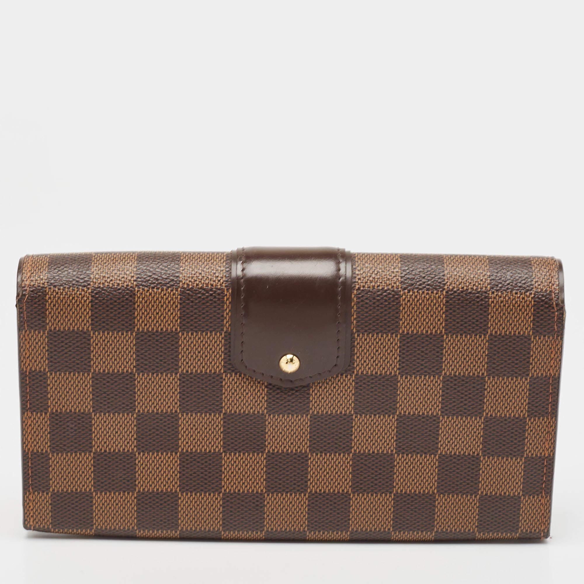 Carry this exquisite wallet by Louis Vuitton in any one of your handbags. Crafted from Damier canvas, it features a polished gold push lock. The interior features compartmentalized to secure your monetary essentials.

