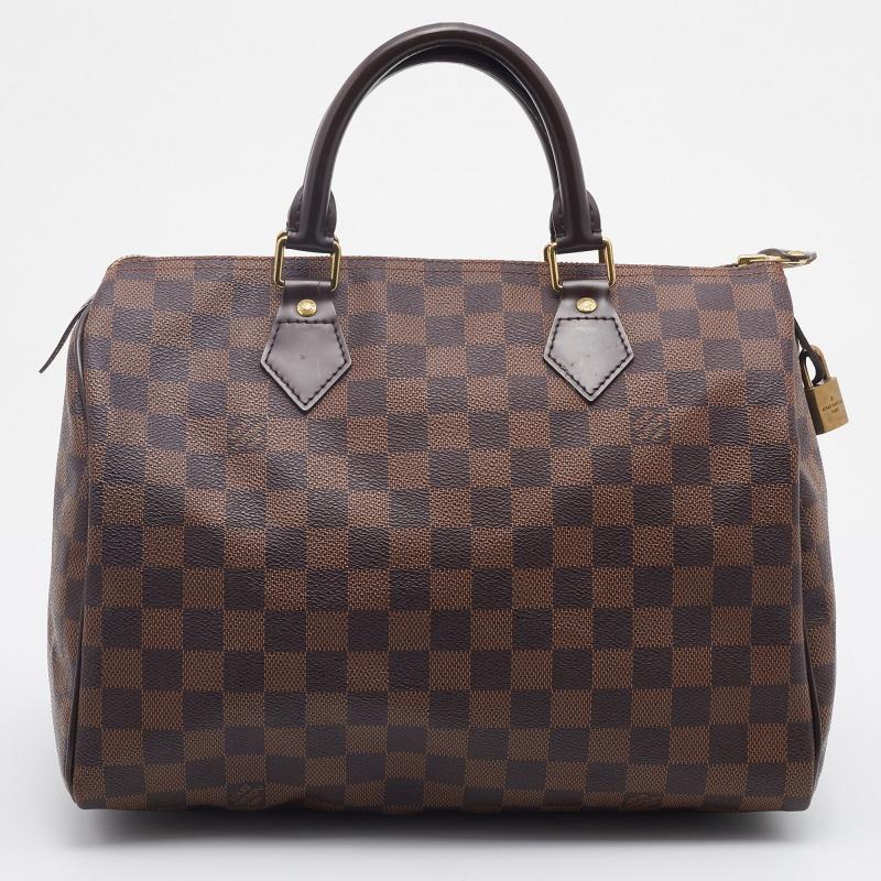 Created to provide you with everyday ease, this Louis Vuitton Speedy 30 bag features dual top handles and a roomy canvas-lined interior. The usage of the Damier Ebene canvas in its construction leads to its instant luxurious identification.