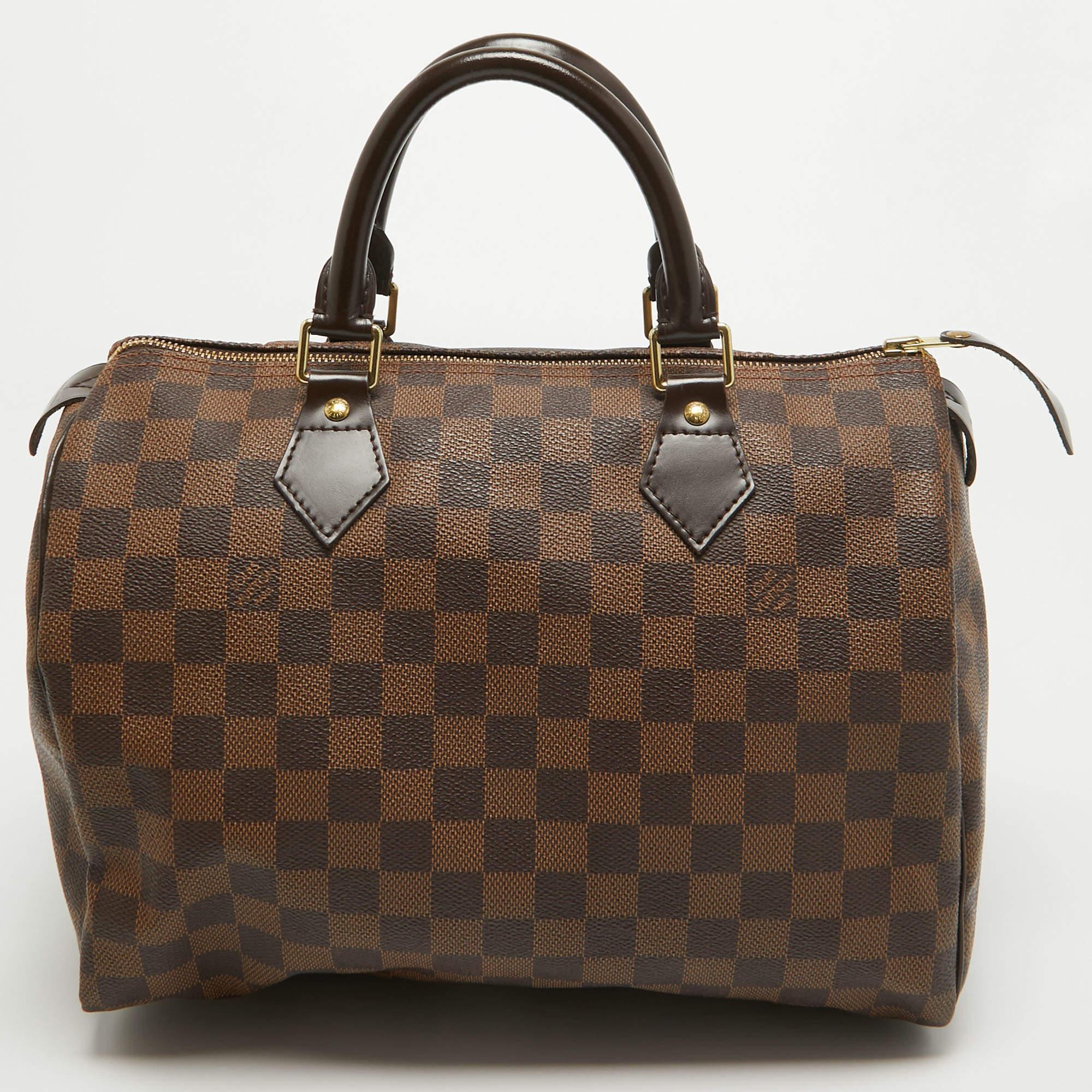 Titled as one of the greatest handbags in the history of luxury fashion, the Speedy from Louis Vuitton was first created for everyday use as a smaller version of their famous Keepall bag. This Speedy comes crafted from signature Damier Ebene coated