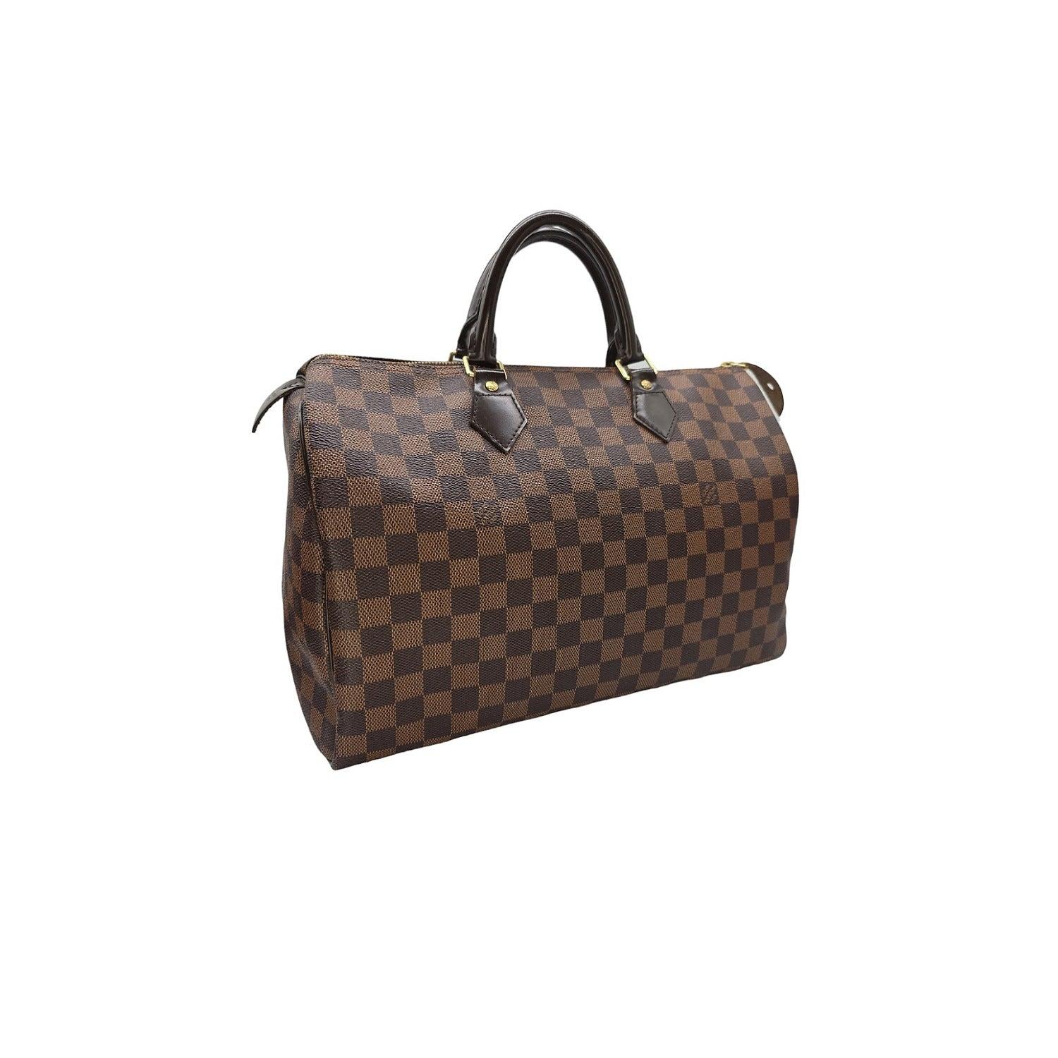 Expertly crafted using Louis Vuitton's signature Damier checkered canvas, this Speedy 35 Satchel exudes style and sophistication. Featuring a spacious interior with a hanging patch pocket, and accented with dark brown leather and polished brass
