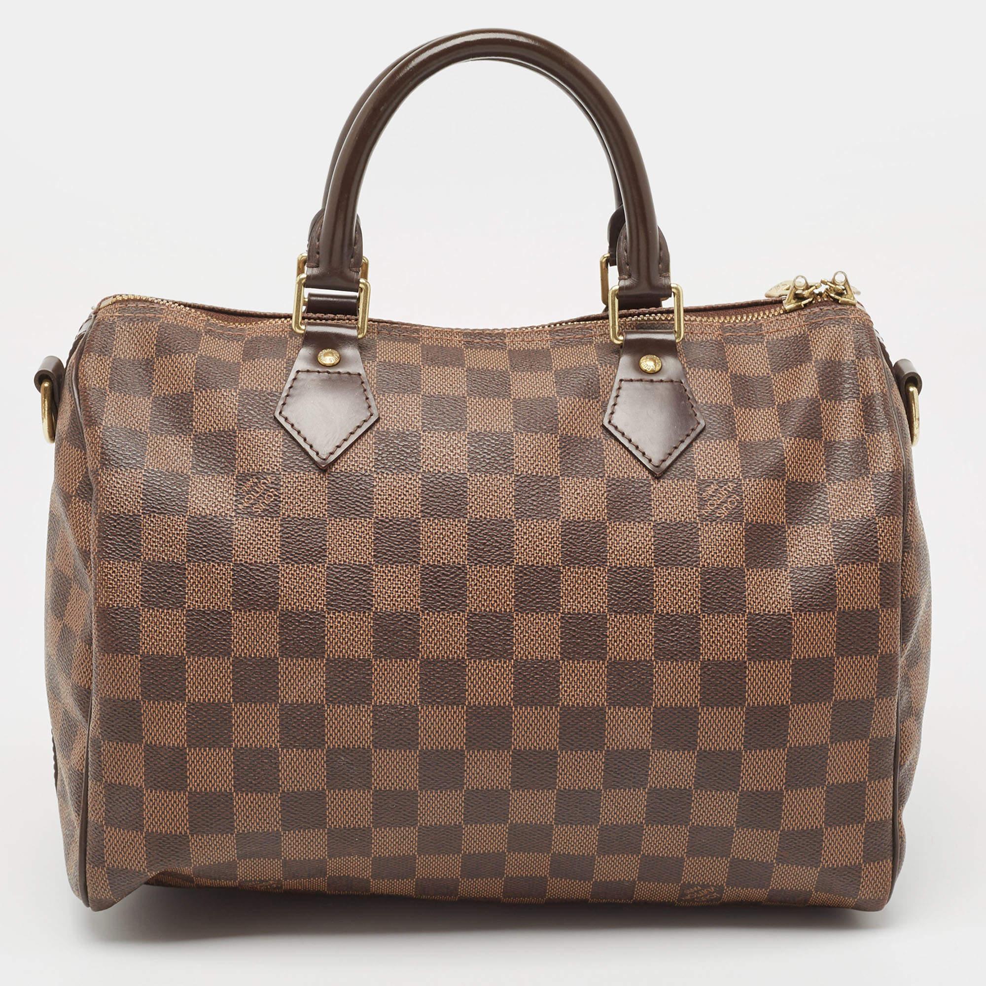 This stylish bag from Louis Vuitton has been crafted from Damier Ebene canvas. It opens to a capacious interior that can easily hold your everyday essentials. The bag is finished with gold-tone hardware and dual handles.

Includes: Original Dustbag,