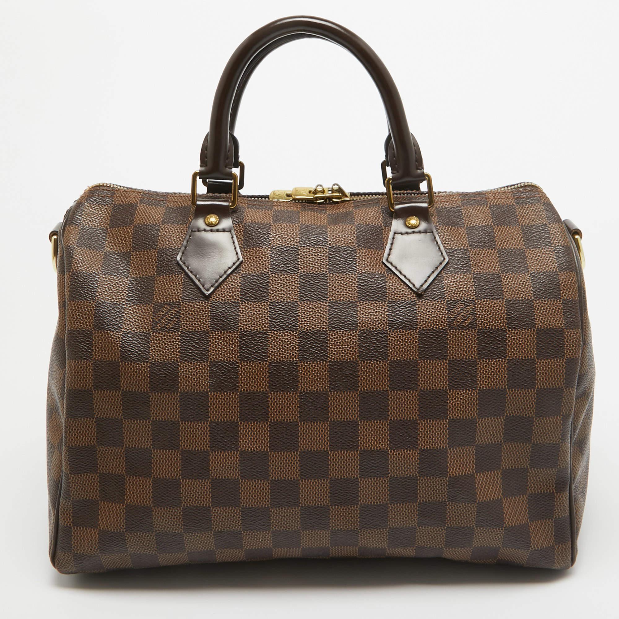 This stylish bag from Louis Vuitton has been crafted from Damier Ebene canvas. It opens to a capacious interior that can easily hold your everyday essentials. The bag is finished with gold-tone hardware and dual handles.

Includes: invoice, Original