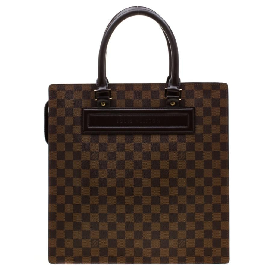 We all know Louis Vuitton is know for making bags that are exquisite and lasting. This Venice Sac Plat tote is a beauty like all the others. It comes crafted from signature Damier Ebene canvas and designed in a structured shape with two handles and