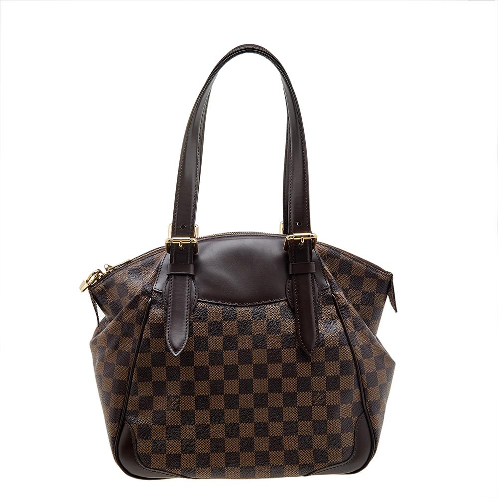 This Louis Vuitton bag is a must-have among all fashionistas! It is crafted from coated canvas and leather and comes with a spacious interior to make it a perfect everyday bag. It shows a brown hue and is complete with dual handles, protective metal