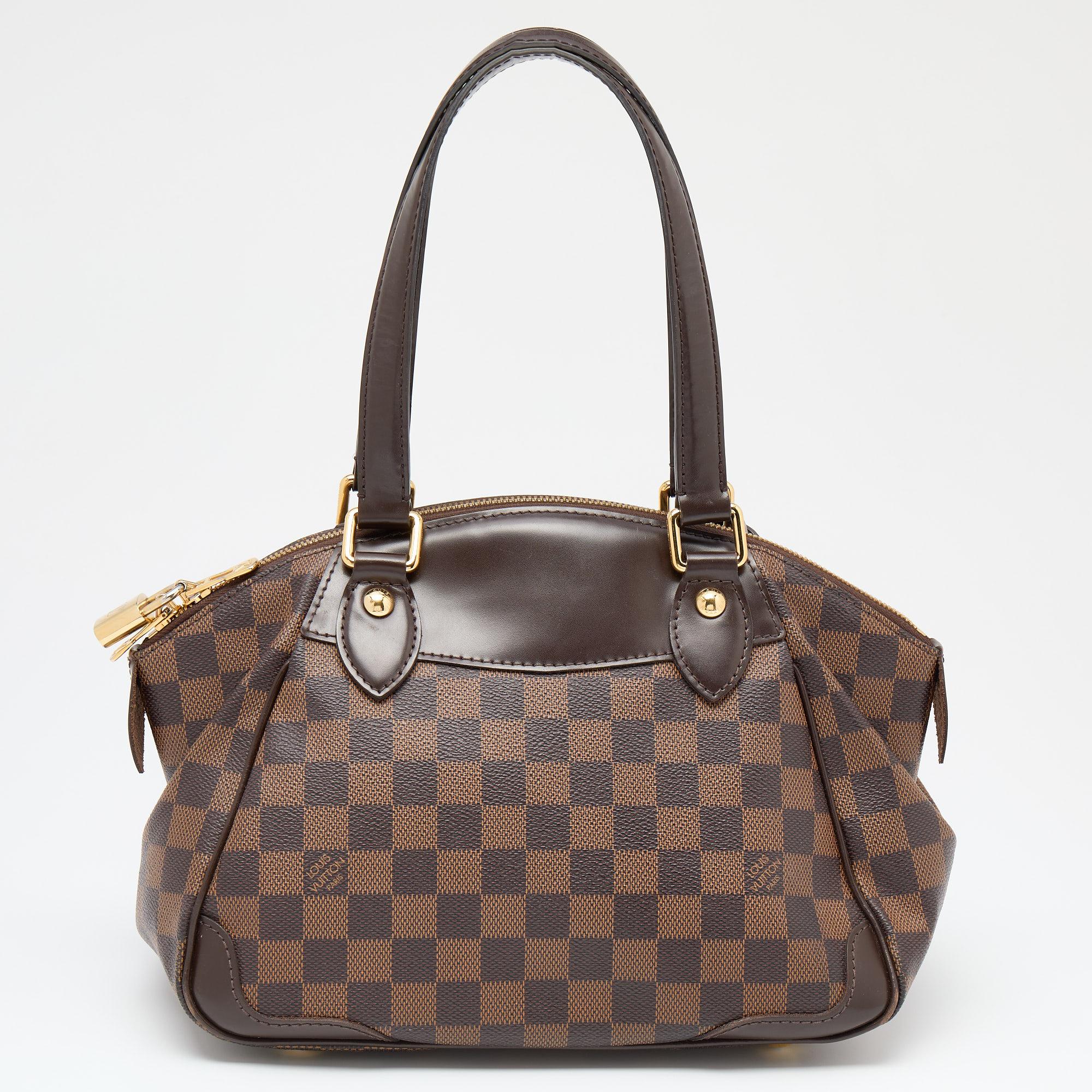 Add this Louis Vuitton bag to your closet for an instant fashion upgrade. It is made from coated canvas and leather and features gold-tone hardware, dual handles, and a capacious interior to hold your important items.