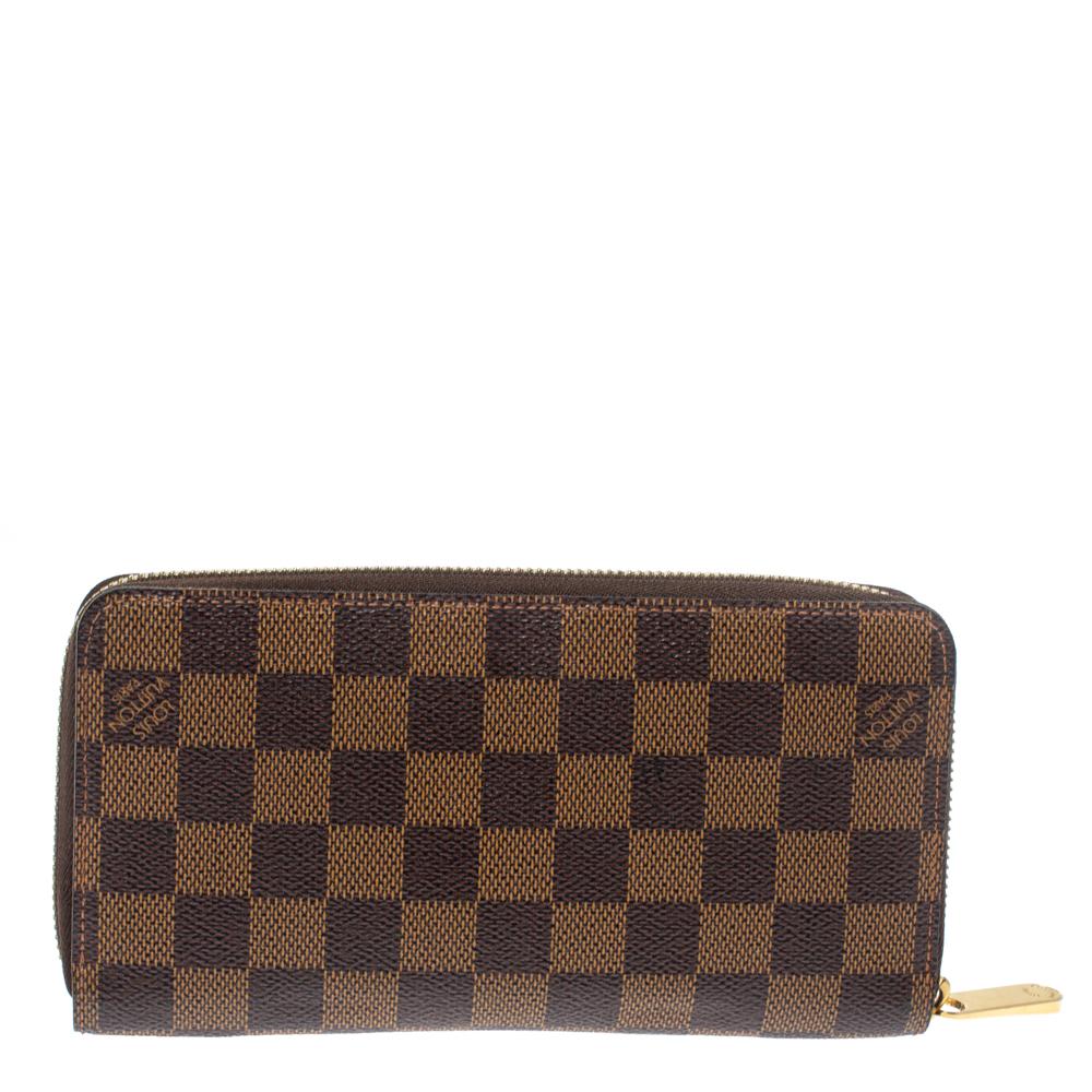 This Louis Vuitton Zippy wallet is conveniently designed for everyday use. Crafted from Damier Ebene coated canvas, the wallet has a zip closure which opens to reveal multiple slots, leather-lined compartments and a zip pocket for you to neatly