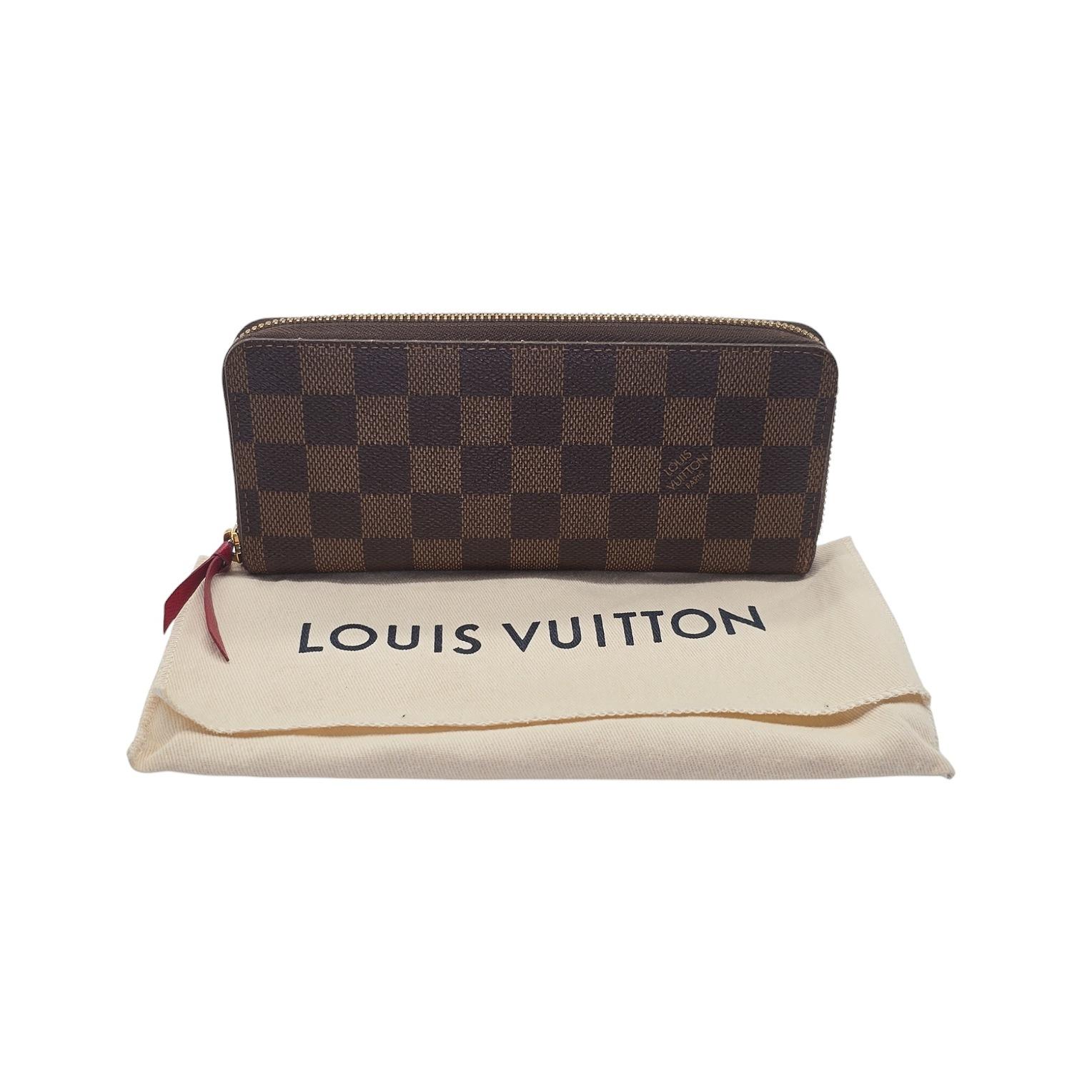 Elevate your everyday with the Louis Vuitton Damier Ebene Clemence Wallet in Cherry. Crafted from the iconic Damier Ebene canvas, this slim-line design boasts a vibrant grained-leather lining and a well-organized interior with multiple compartments