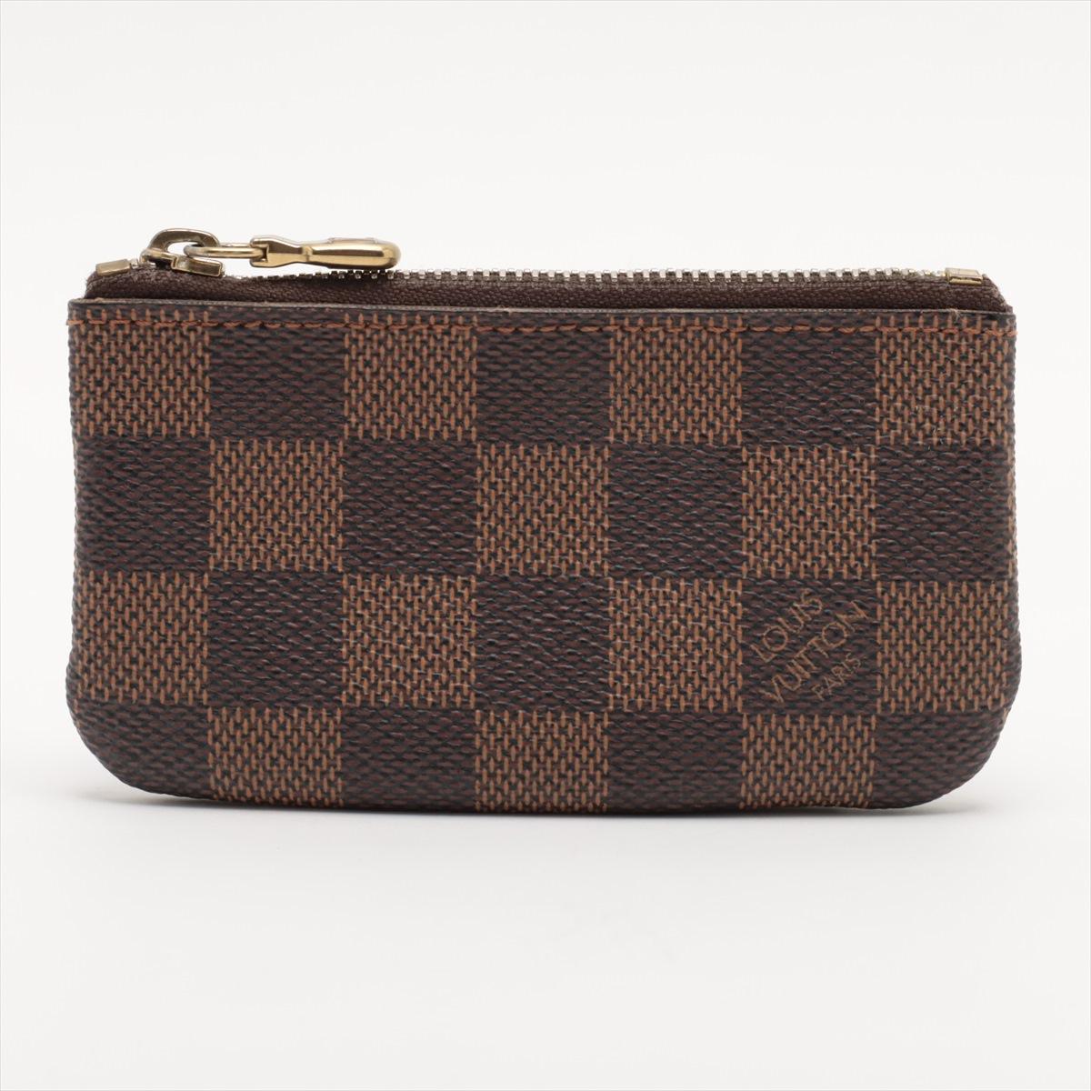 The Louis Vuitton Damier Ebene Coin Case is a compact and stylish accessory that seamlessly blends practicality with iconic design. Crafted with meticulous attention to detail, the coin case features the classic Damier Ebene canvas, showcasing the
