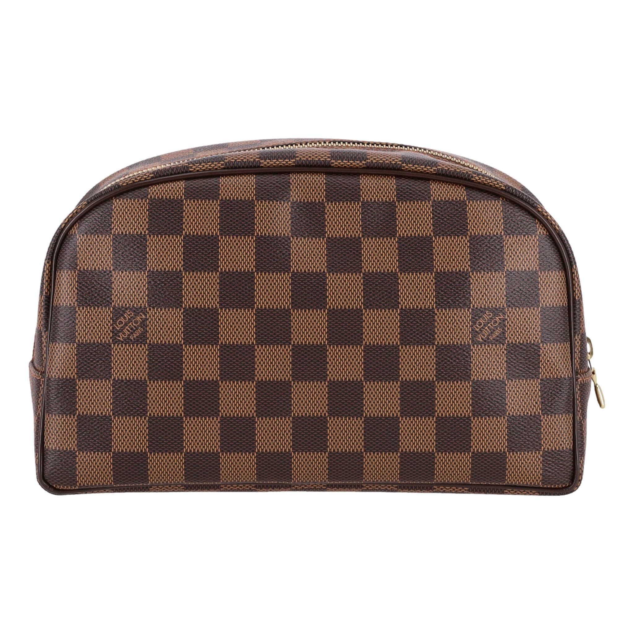 Louis Vuitton Damier Ebene Cosmetic/Toiletry Pouch

Brown cosmetic bag crafted from signature Damier Ebene coated canvas.

Featuring a gold zipper closure leading to leather interior with zipped pocket.

Rrp Approx. £415

Size – Height 16cm, Width