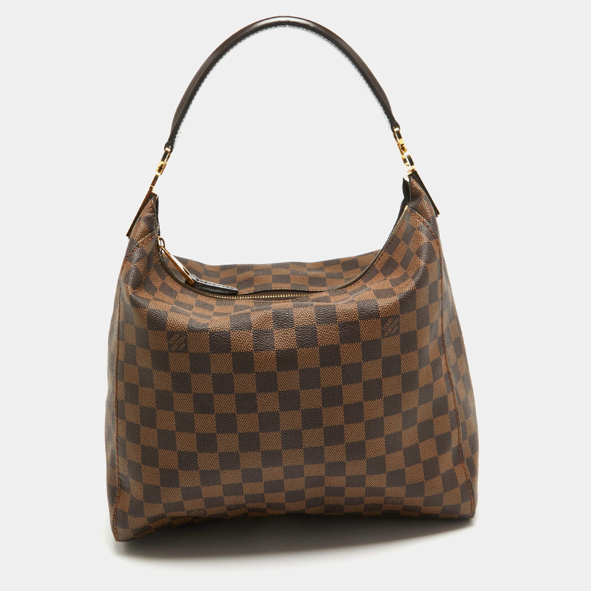 This stunning bag by Louis Vuitton is a must-have. Crafted from the brand's signature Damier Ebene canvas, it features a single handle, gold-tone hardware, and a zip closure that opens to a spacious lined interior. This Duomo bag is a versatile