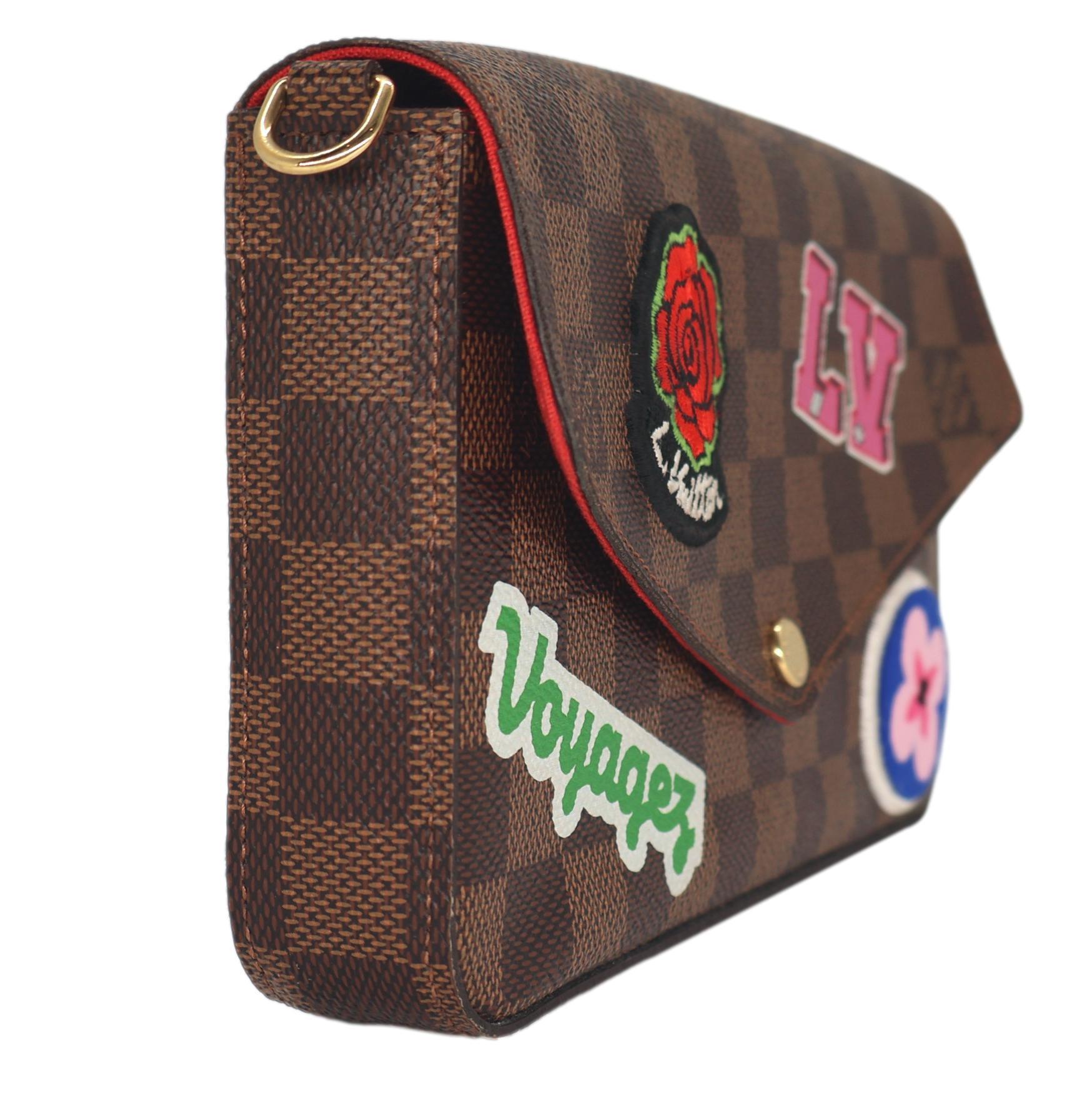 Louis Vuitton Damier Ebene Limited Edition World Tour Pochette Félicie, 2018. This iconic pochette is a piece of Louis Vuitton history that was first introduced in the the early 1900's as an accessory pouch to accompany larger bags. As the early