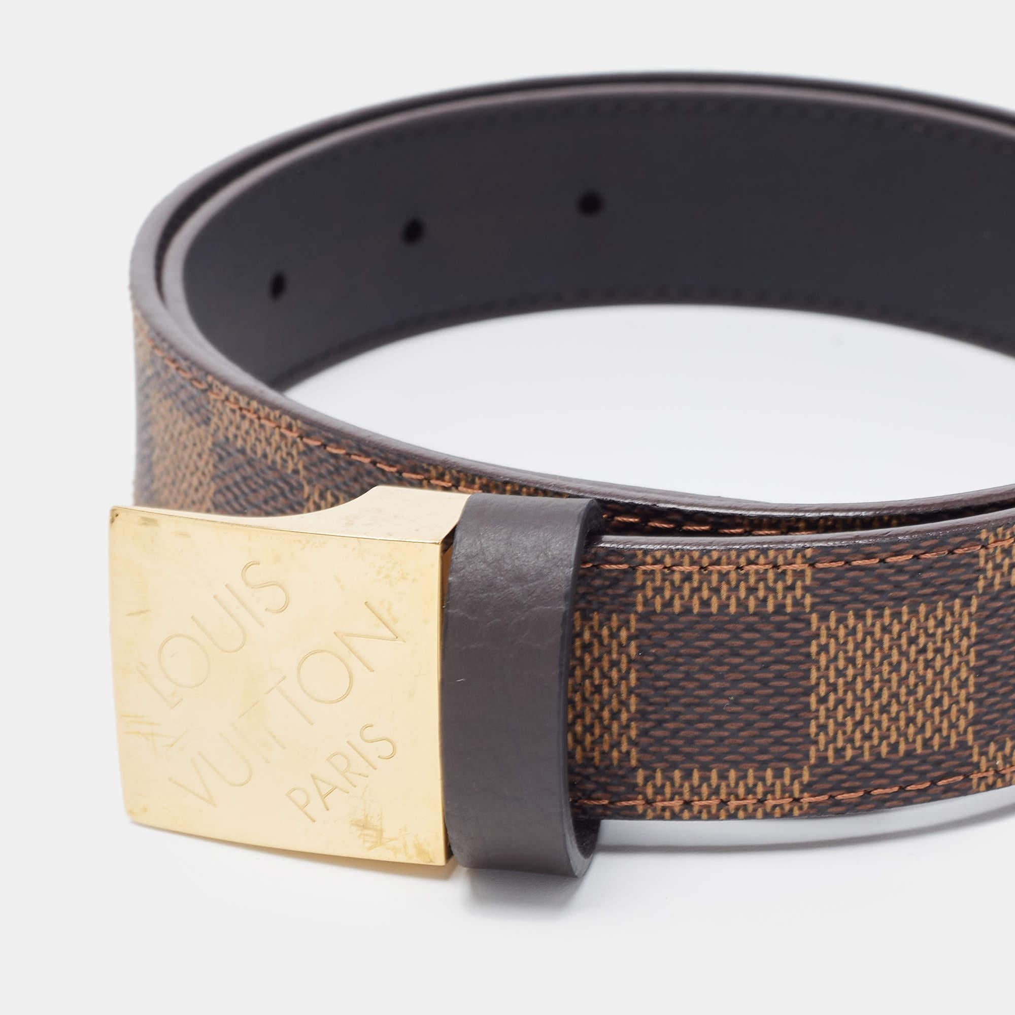 This belt from Louis Vuitton is crafted with Damier Ebene canvas and elevated with gold-tone metal ccents. The brown hue will surely complement any ensemble, while the metal buckle emulates the signature style. Style yours with a pair of casual