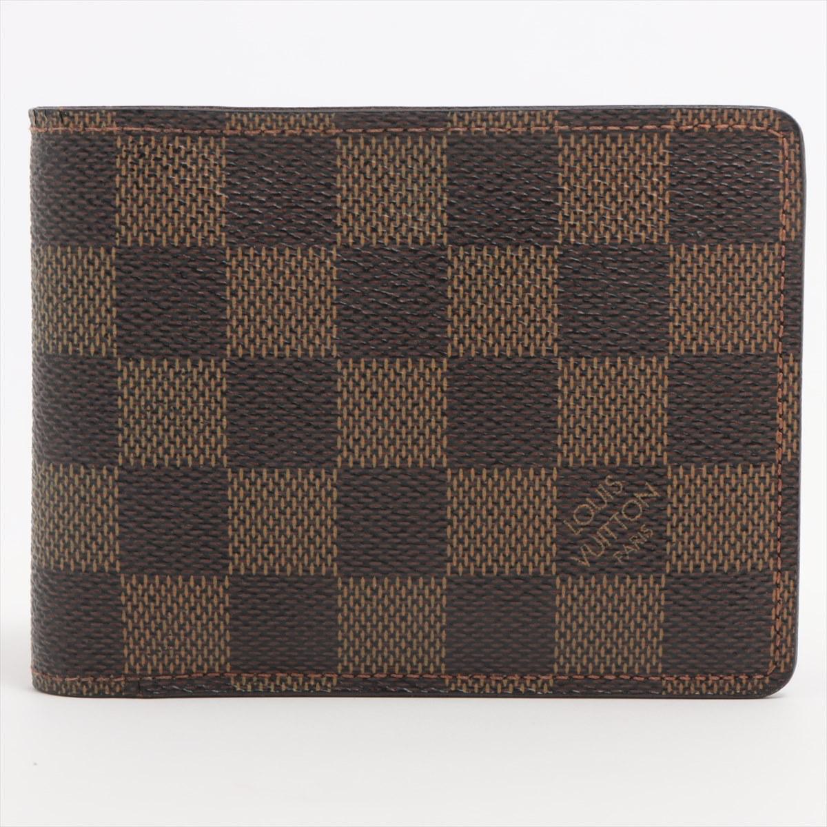 The Louis Vuitton Damier Ebene Multiple Wallet a refined and practical accessory that seamlessly combines luxury with everyday functionality. Meticulously crafted from the iconic Damier Ebene canvas, the wallet features the classic brown