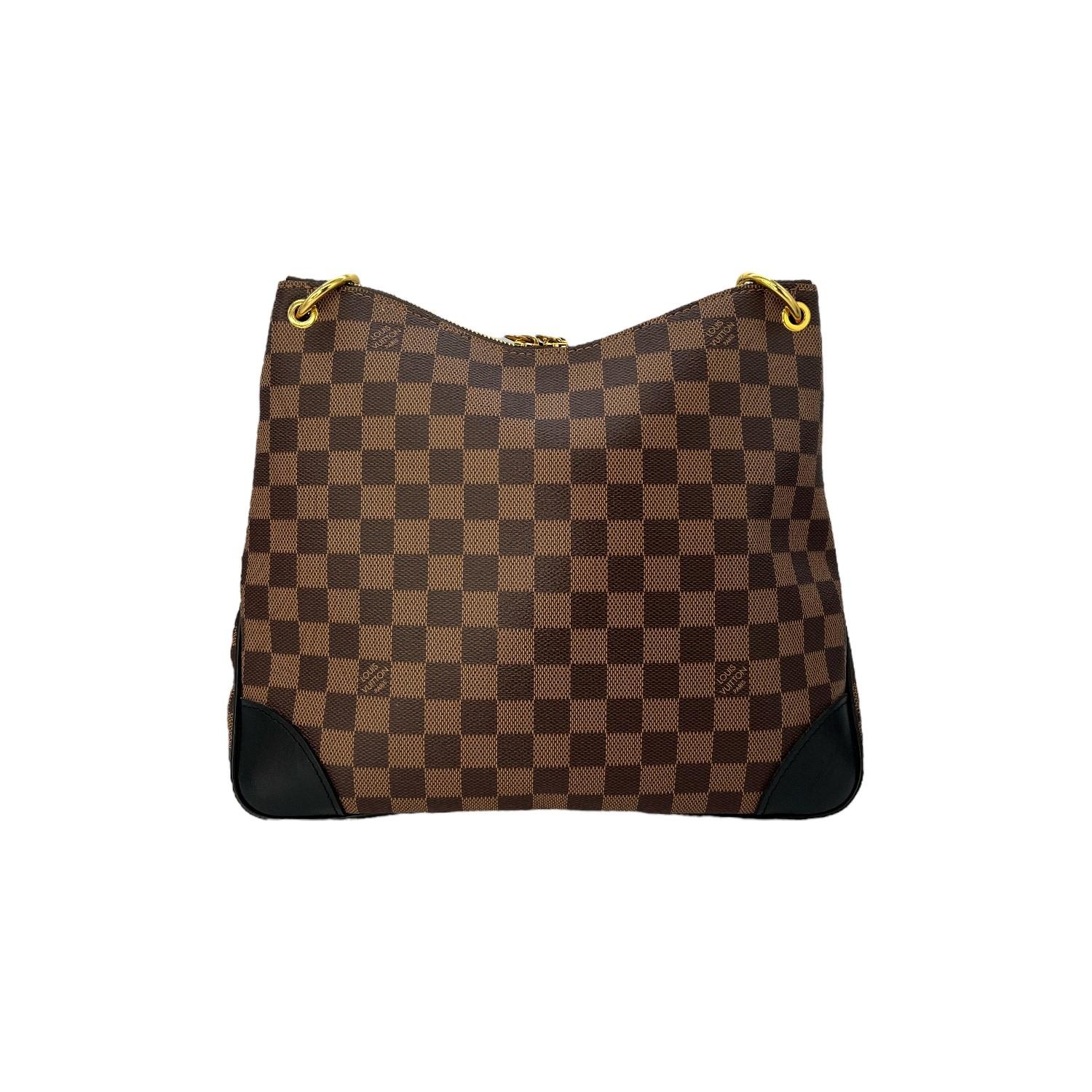 This Louis Vuitton Damier Ebene Odeon PM is finely crafted of the classic Louis Vuitton Damier Ebene coated canvas with leather trimming and gold-tone hardware features. It has a flat black leather shoulder strap. It has a frontal slip pocket that