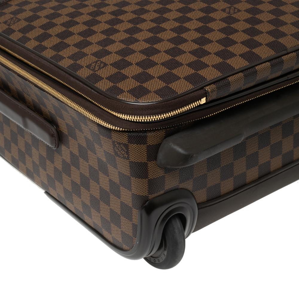 Taking Louis Vuitton's legendary art of travel elegantly forward, the Pegase 55 suitcase, crafted from Damier Ebene canvas and leather, flaunts traditional craftsmanship and an innovative, modern design. Lightweight, robust, and ultra-mobile, it
