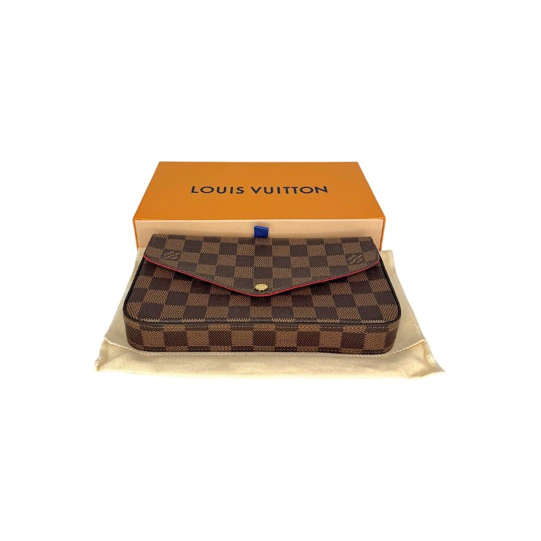 This Louis Vuitton Pochette Felice was made in the USA in 2020 and it is finely crafted of a Louis Vuitton Damier Ebene canvas exterior with leather trimming and gold-tone hardware features. It includes a removeable leather shoulder strap. It has a