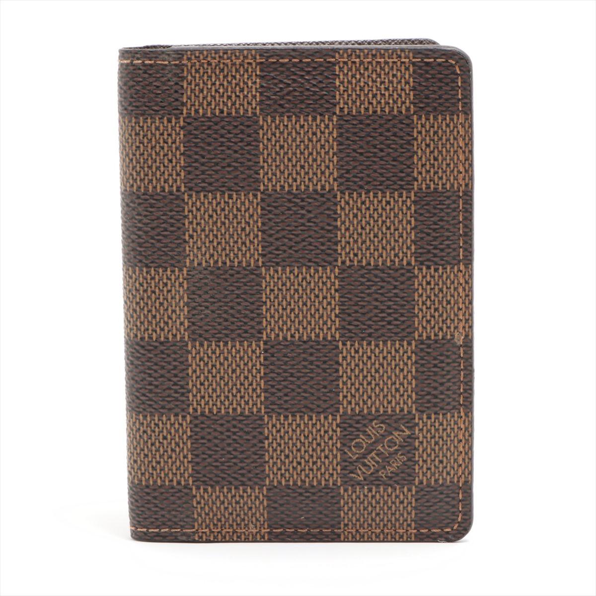 The Louis Vuitton Damier Ebene Pocket Organizer is a compact and stylish accessory designed for optimal organization. Crafted from the iconic Damier Ebene canvas, the organizer exudes timeless sophistication. The exterior features a subtle