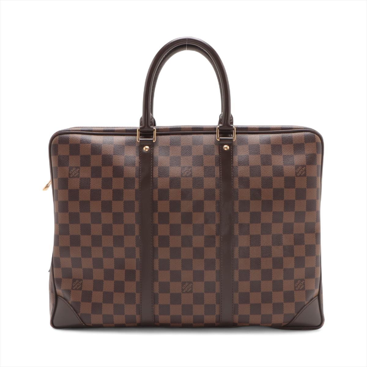 The Louis Vuitton Damier Ebene Porte-Documents Voyage is a sophisticated and functional briefcase crafted from the brand's signature Damier Ebene canvas with elegant leather trim. Designed for the modern professional, it features a structured