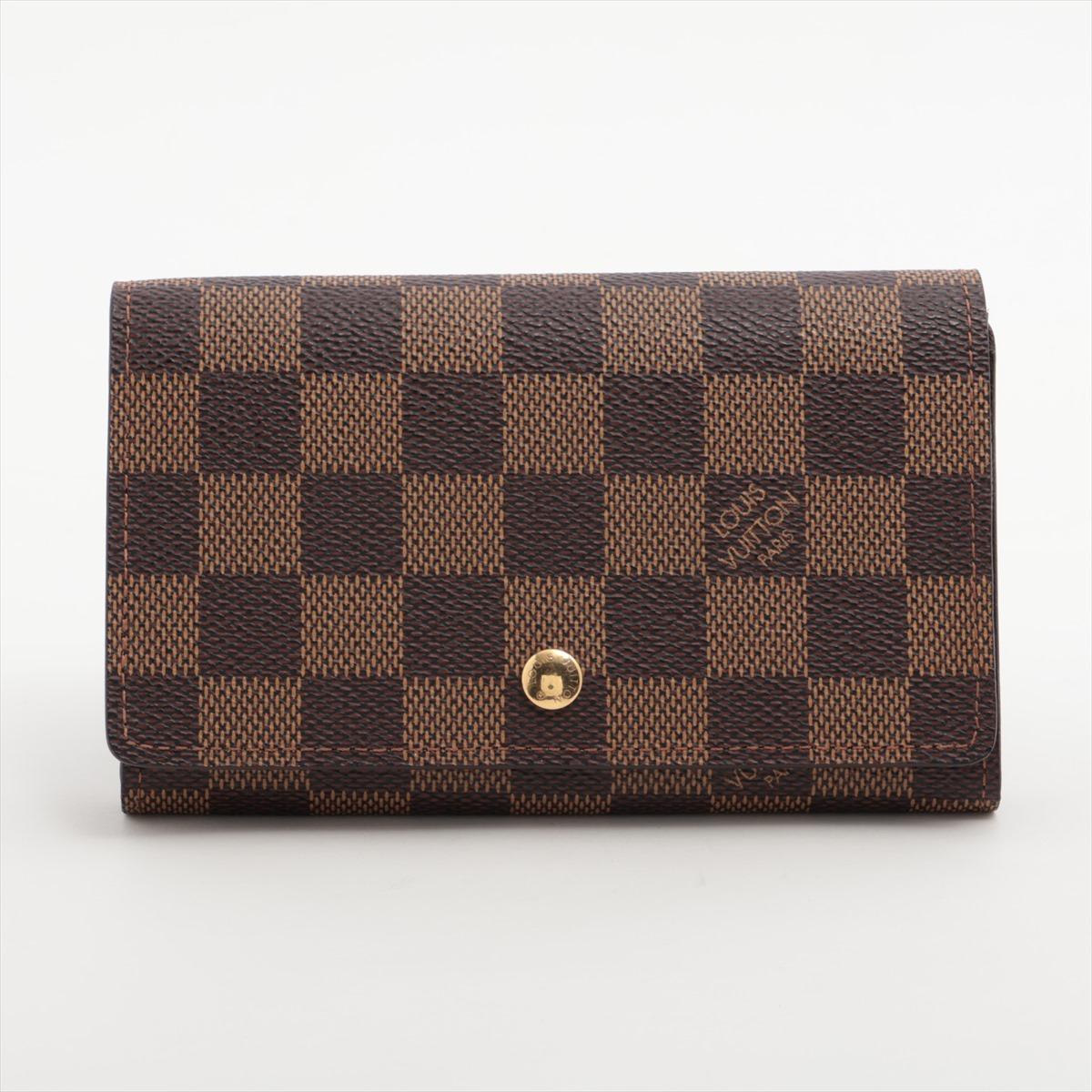 The Louis Vuitton Damier Ebene Porte Monnaie Billets Tresor Wallet a refined and practical accessory showcasing the timeless elegance of the Damier Ebene canvas. Crafted with meticulous attention to detail, the wallet boasts a classic checkerboard