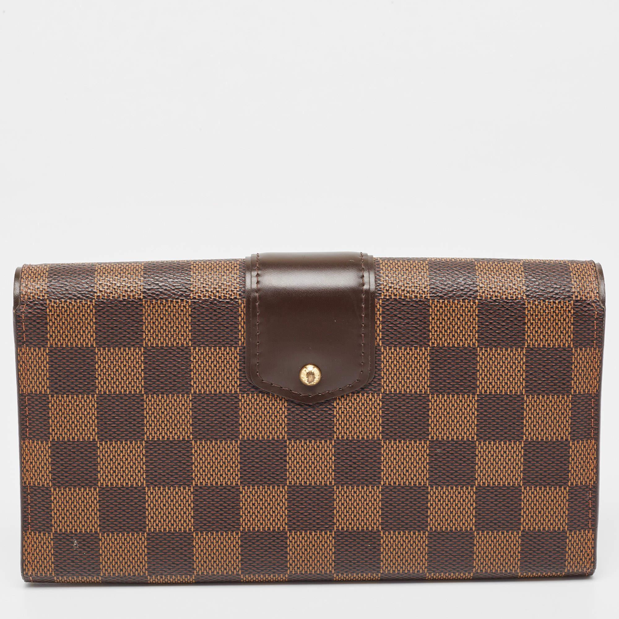 Carry this exquisite wallet by Louis Vuitton in any one of your handbags. Crafted from Damier canvas, it features a polished gold push lock. The interior features compartmentalized to secure your monetary essentials.

