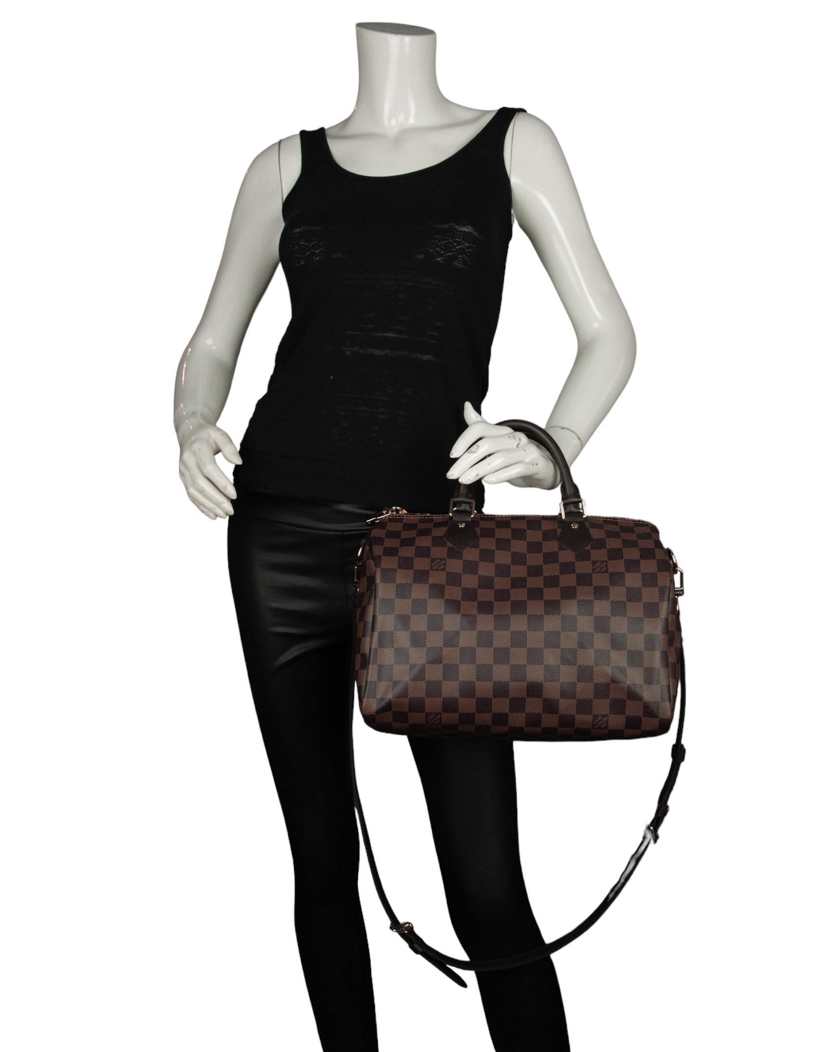 Louis Vuitton Damier Ebene Speedy Bandouliere 30 Bag

Made In: U.S.A
Color: Brown
Hardware: Goldtone
Materials: Coated canvas with leather trim
Lining: Fine textile
Closure/Opening: Zip top
Exterior Pockets: None
Interior Pockets: One zip