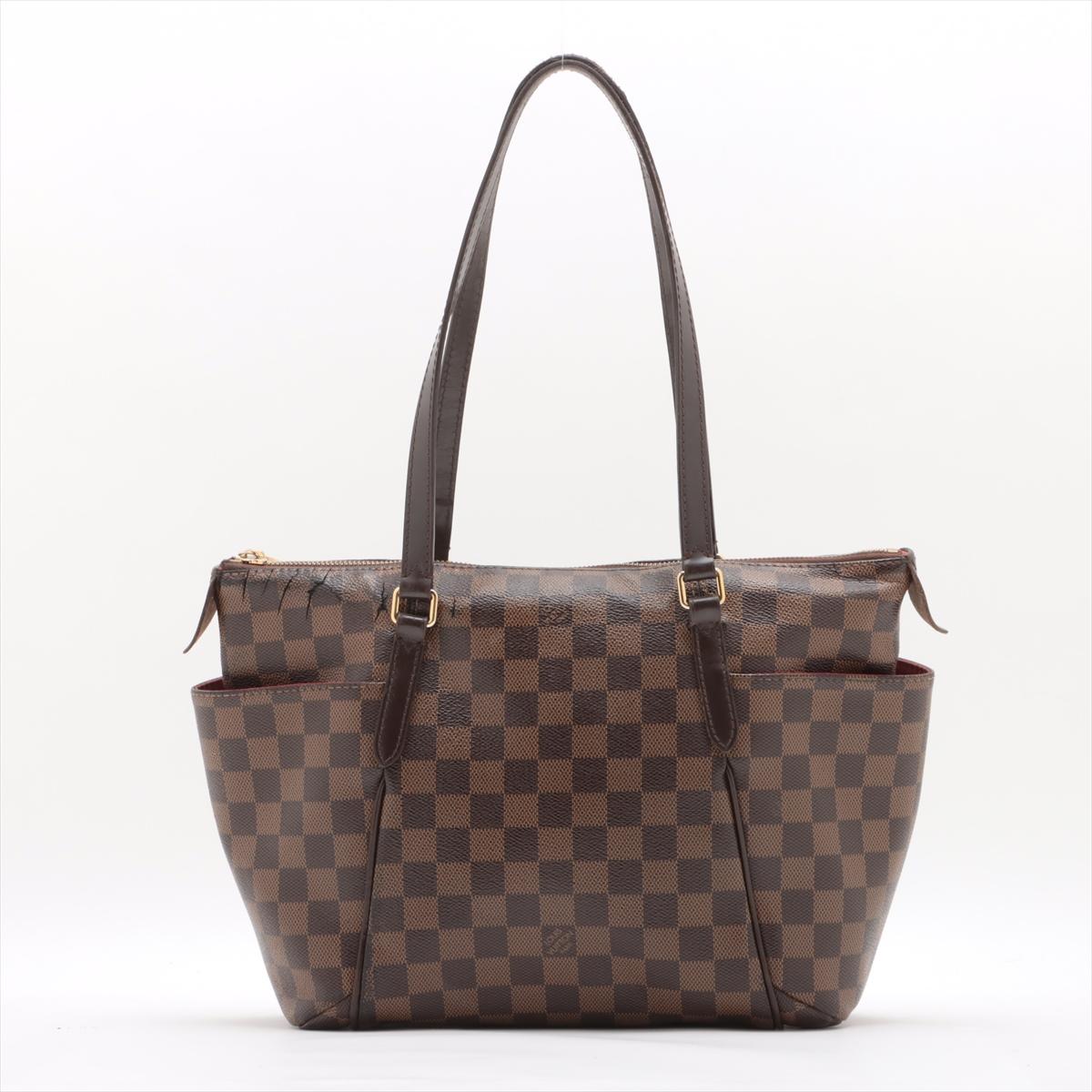 RANK: B- (some heavy cracking near zipper)

The Louis Vuitton Damier Ebene Totally PM is a chic and functional handbag designed for modern elegance. Crafted from durable Damier Ebene canvas, it showcases the iconic checkered pattern in rich brown