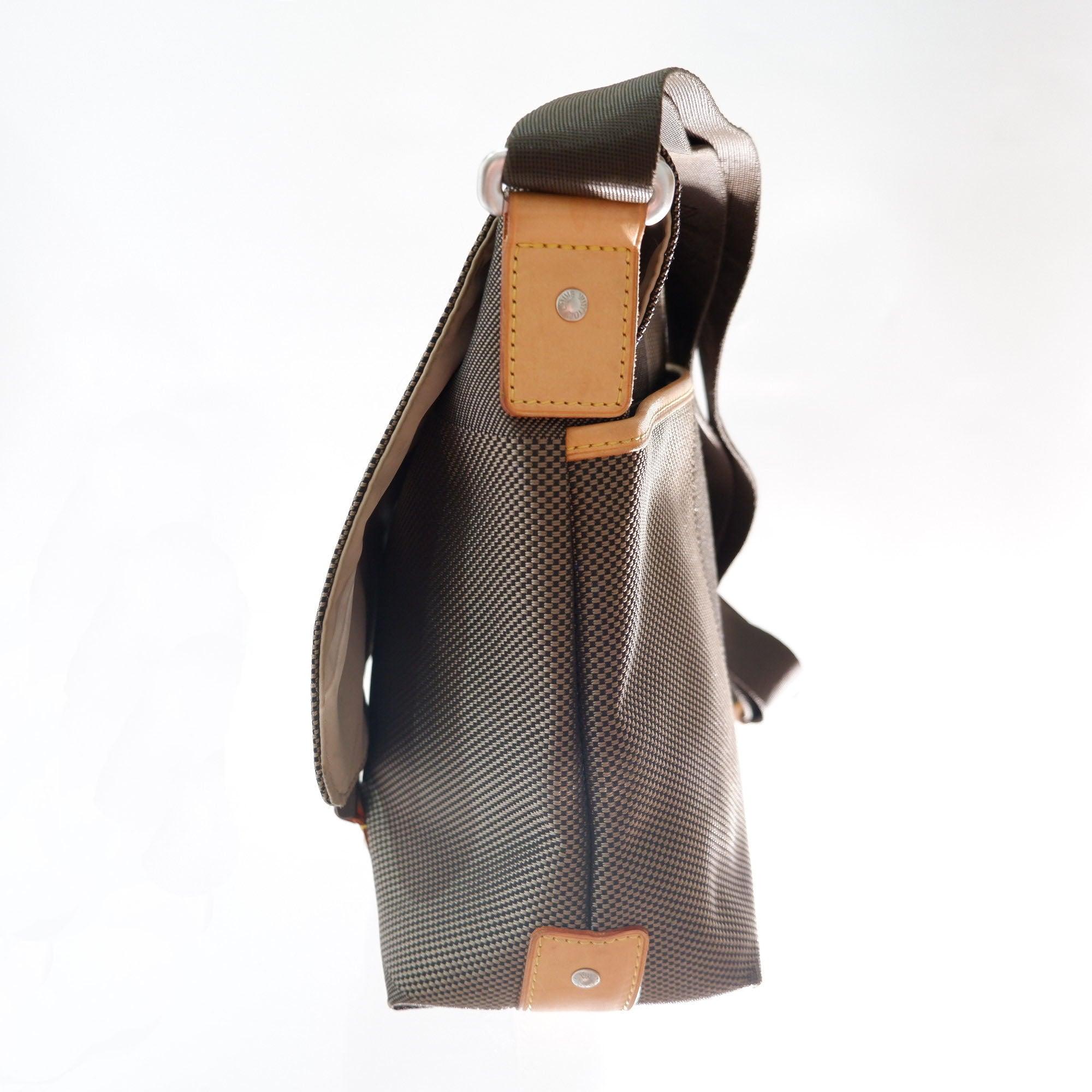 Men's tawny jacquard nylon Louis Vuitton Damier Geant Loup messenger bag with silver-tone hardware, tan vachetta leather trim, single adjustable brown nylon shoulder strap, single pocket at exterior with zip closure, beige nylon lining, dual pockets