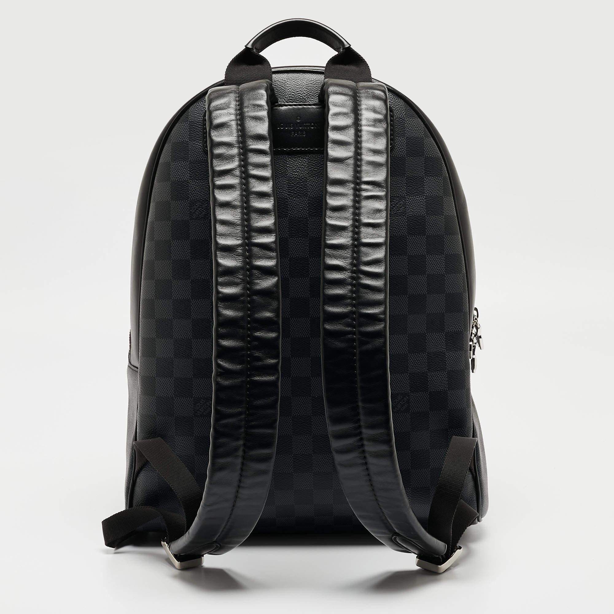 This stylish Josh backpack from Louis Vuitton is made from the signature Damier Graphite canvas and leather and is enhanced with a zipped pocket at the front. The bag features a top handle and two shoulder straps. It has a spacious interior that is
