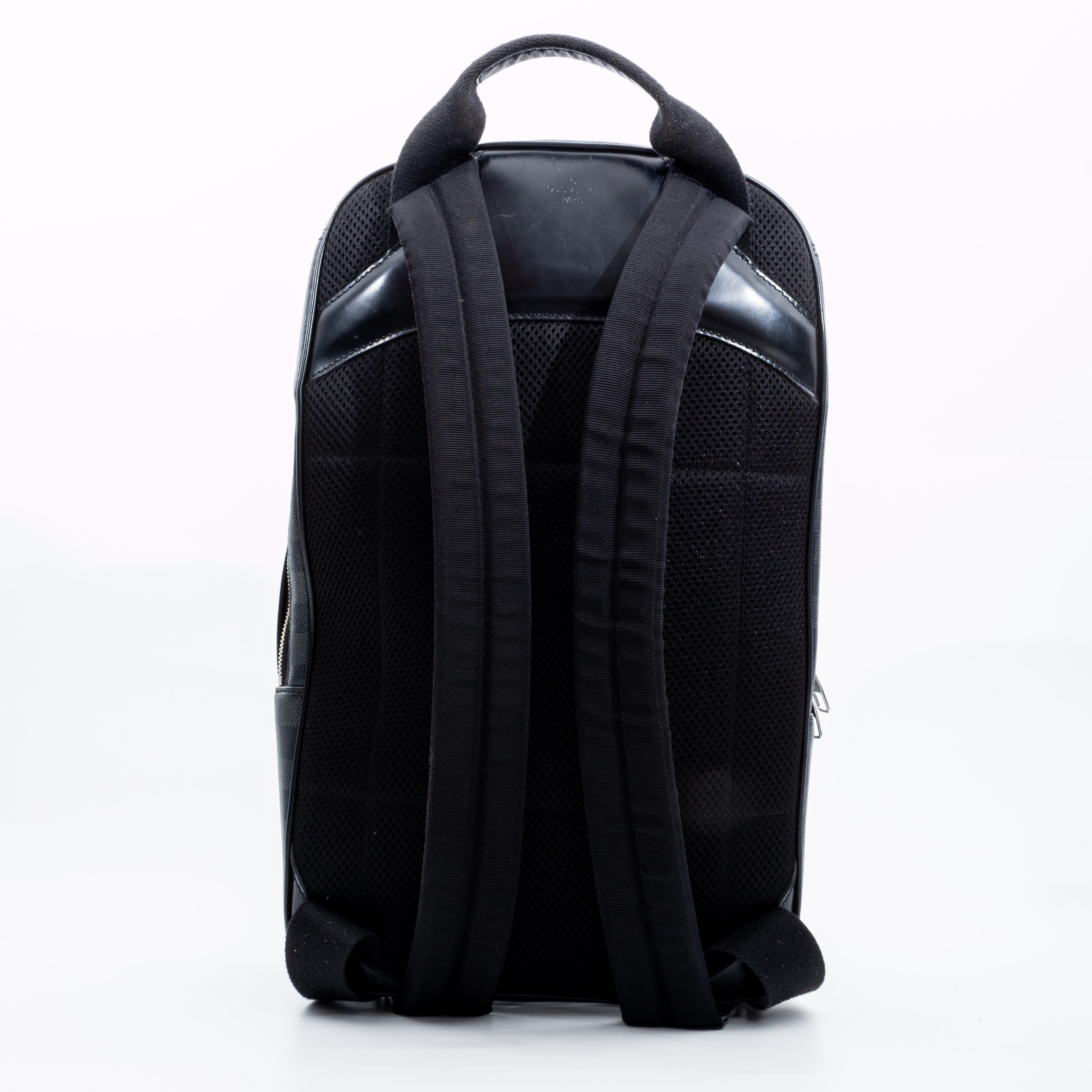 The Michael backpack is a sleek, modern design in Damier Graphite canvas with black leather trim. Geared to active lifestyles, it can be carried in the hand or on the shoulder. Its main compartment features a secure and convenient double zip closure