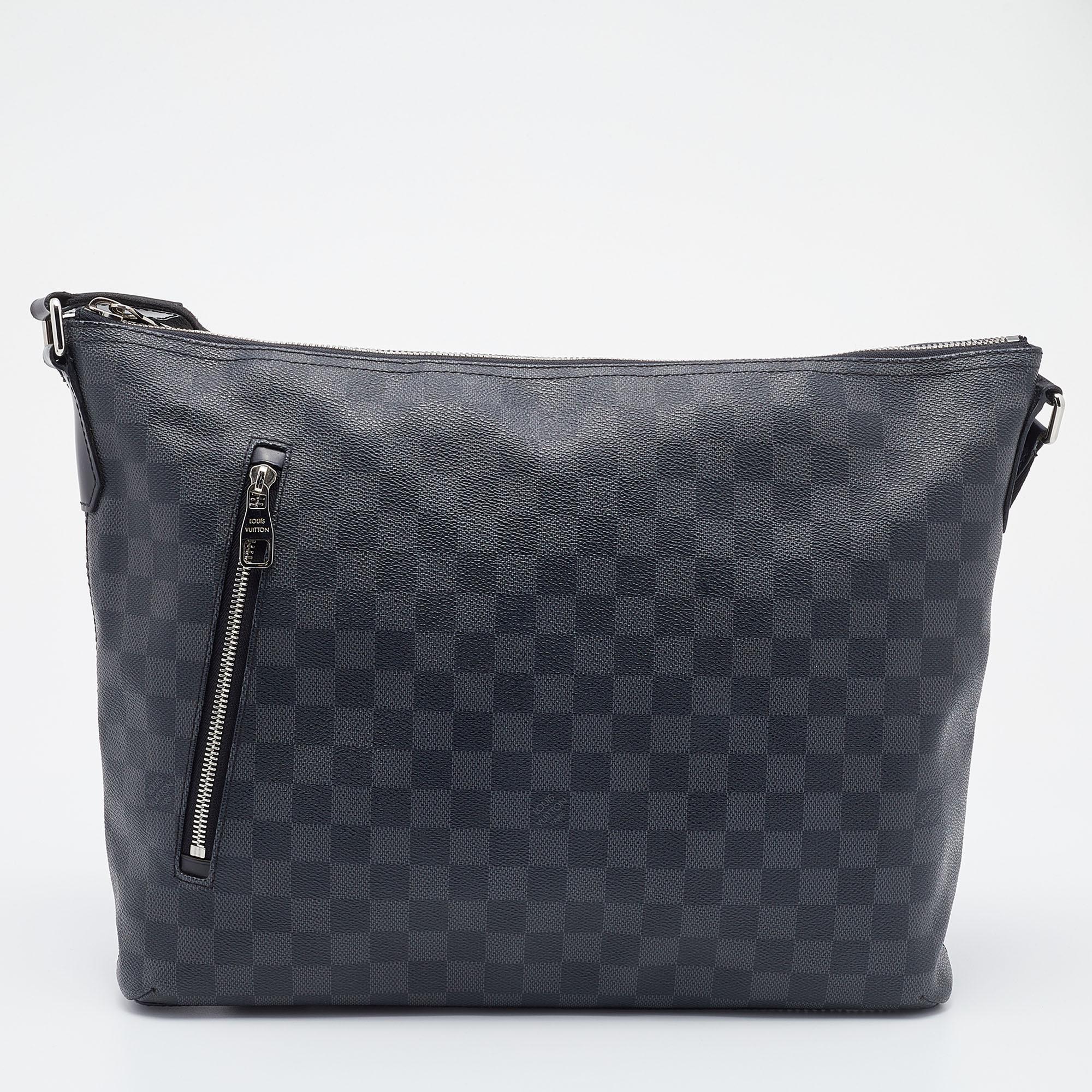 Filled with functional characteristics, this Louis Vuitton Mick GM bag is the epitome of sophistication and luxury. It can be carried around with a shoulder strap, and the silver-tone accents add to its charm. Crafted from Damier Graphite canvas,
