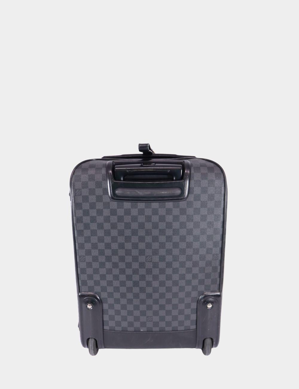 Travel in timeless luxury with this Louis Vuitton carry-on luggage crafted in sleek Damier Graphite canvas. Lightweight yet structured, it features a spacious interior, external zip pocket, and smooth leather trim for a refined finish. The discreet