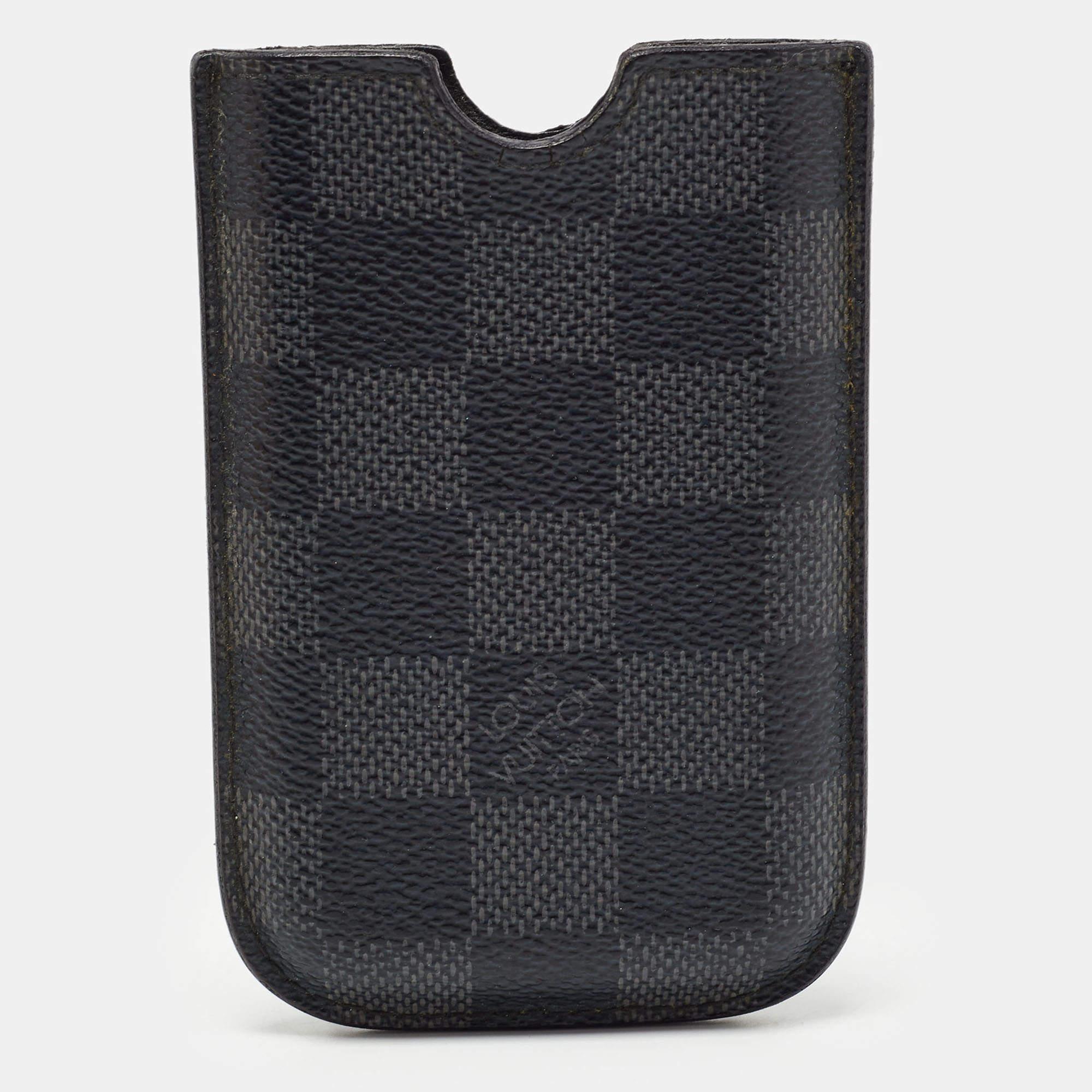 Crafted using Damier Graphite canvas  this phone case by Louis Vuitton is sized to carefully hold your phone. It has a fine finish and an Alcantara lined interior.