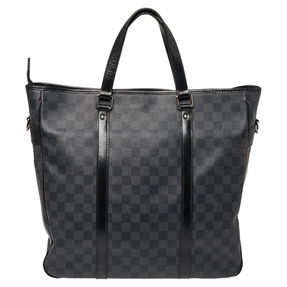 Designed as the perfect everyday bag, this Louis Vuitton Tadao bag will become your favorite thing to carry on the go. Its stylish Damier Graphite-printed canvas is coupled with black leather trims and silver-tone hardware. This bag has double top