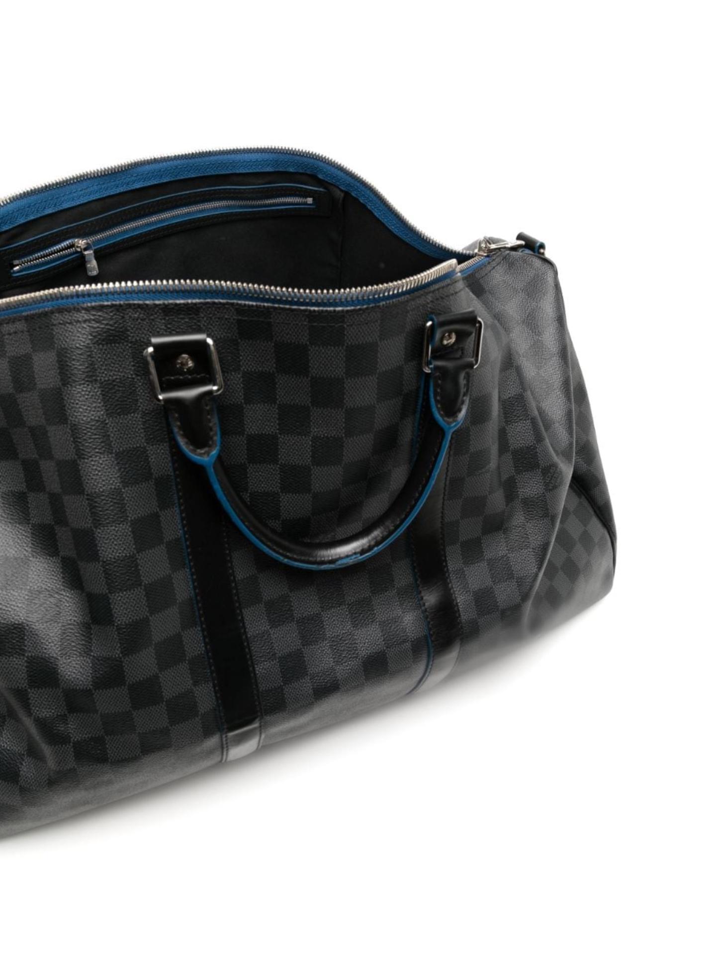 * Black/Grey signature Damier Graphite canvas
* Contrasting blue details
* Leather trim
* Two rolled top handles
* Adjustable detachable shoulder strap
* Two-way zip fastening
* Main compartment
* Internal zip-fastening pocket
* Silver-tone