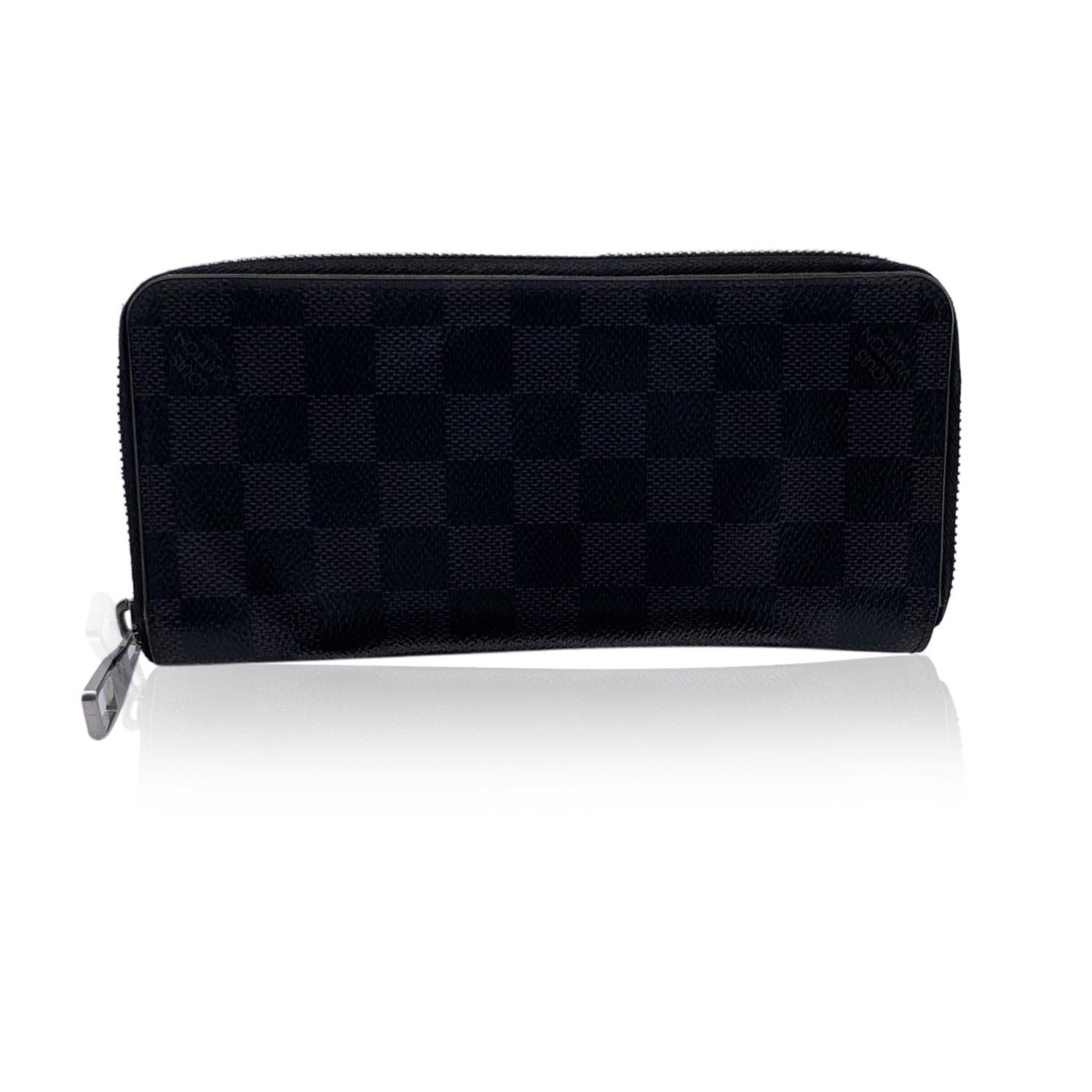 LOUIS VUITTON Damier Graphite Zippy Wallet. Zip closure. It features 2 open pockets, 1 zip coin compartment, 3 flat open pocket. 14 credit card slots. 'LOUIS VUITTON Paris - made in Spain' embossed inside. Authenticity serial number CA2178 embossed