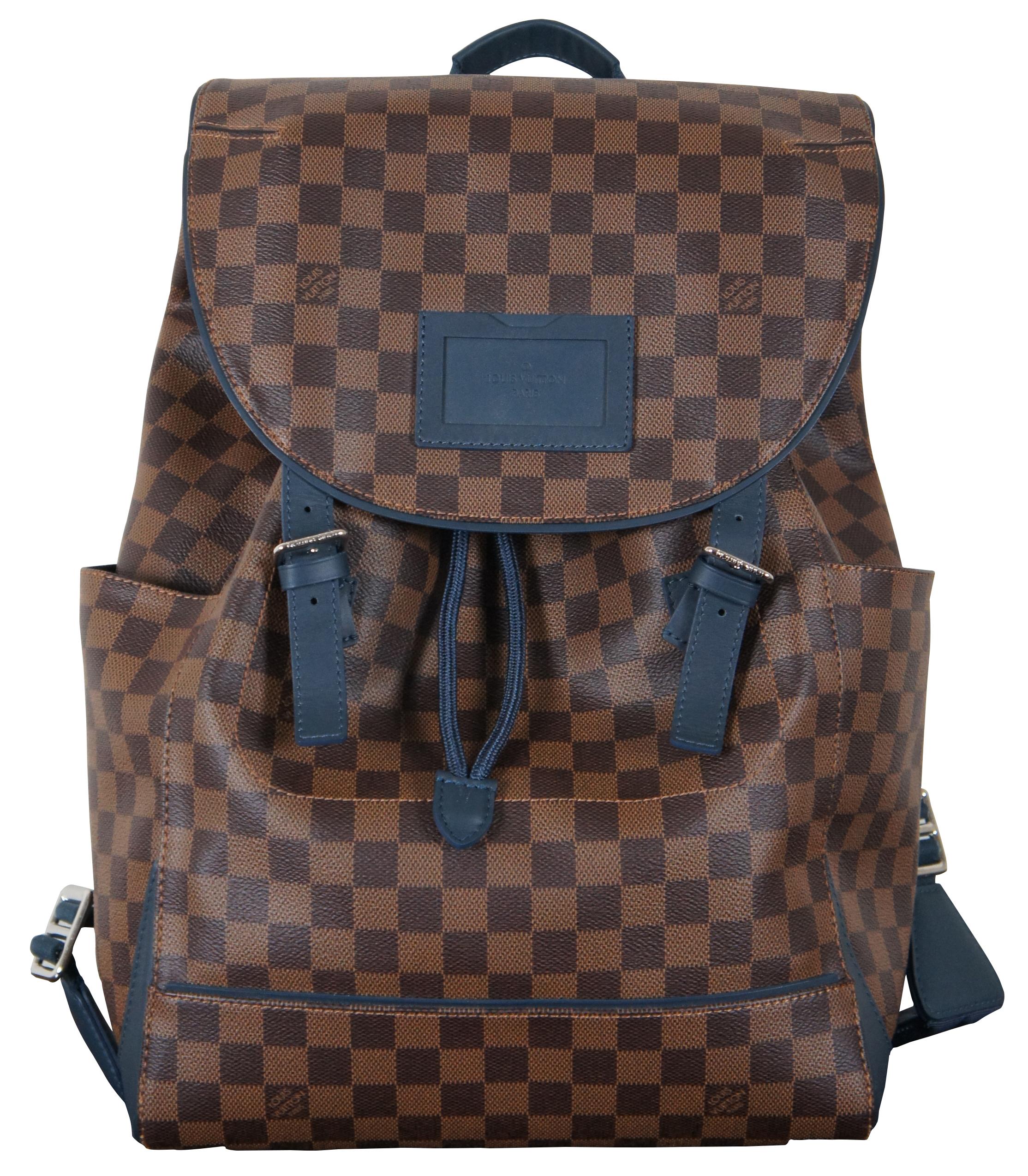 100% Authentic Louis Vuitton Damier Ebene runner backpack in brown check with navy blue leather trim. Includes dust bag and original tags.
 