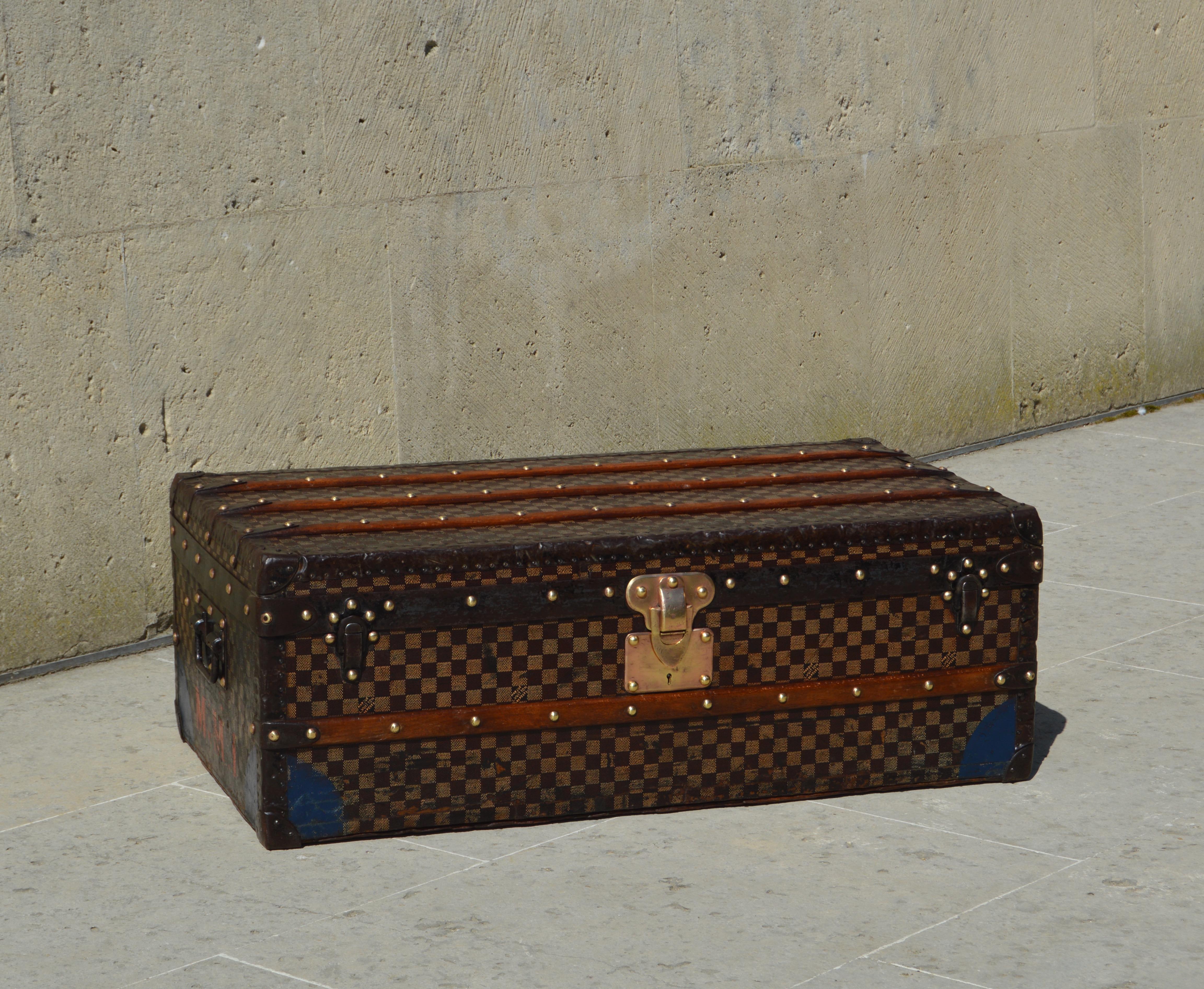 Superb Louis Vuitton trunk from 1893 covered with the first checkerboard fabric of the brand. The term 