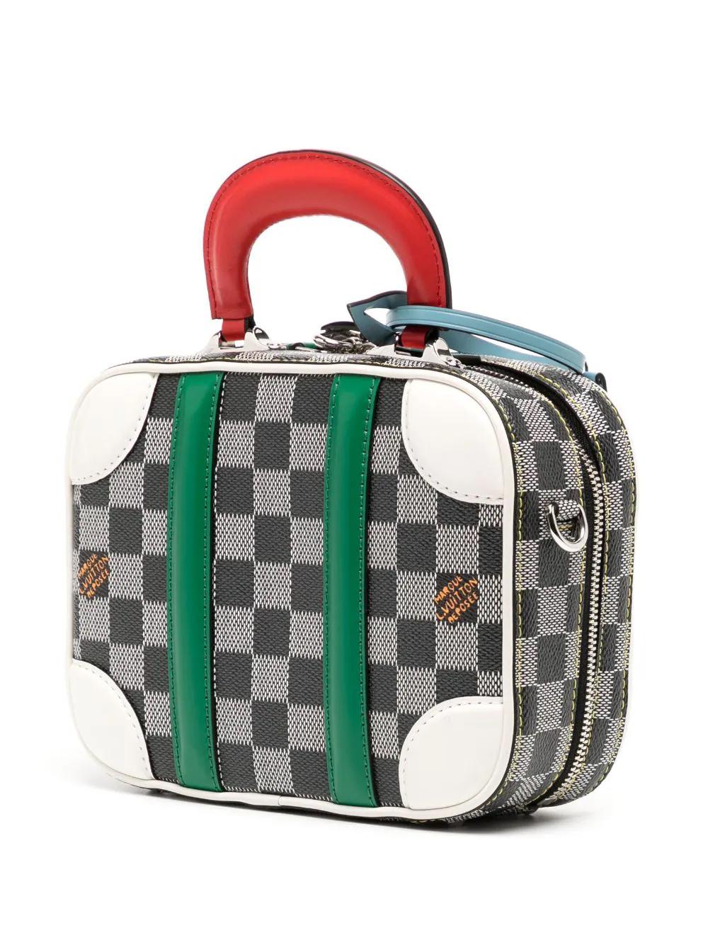 This one-of-a-kind Valisette from Louis Vuitton's Fall/Winter 2019 collection combines classic travel style with modern functionality. It has a two-way zip closure, a vibrant red top handle, and a removable long strap to accommodate your needs. The