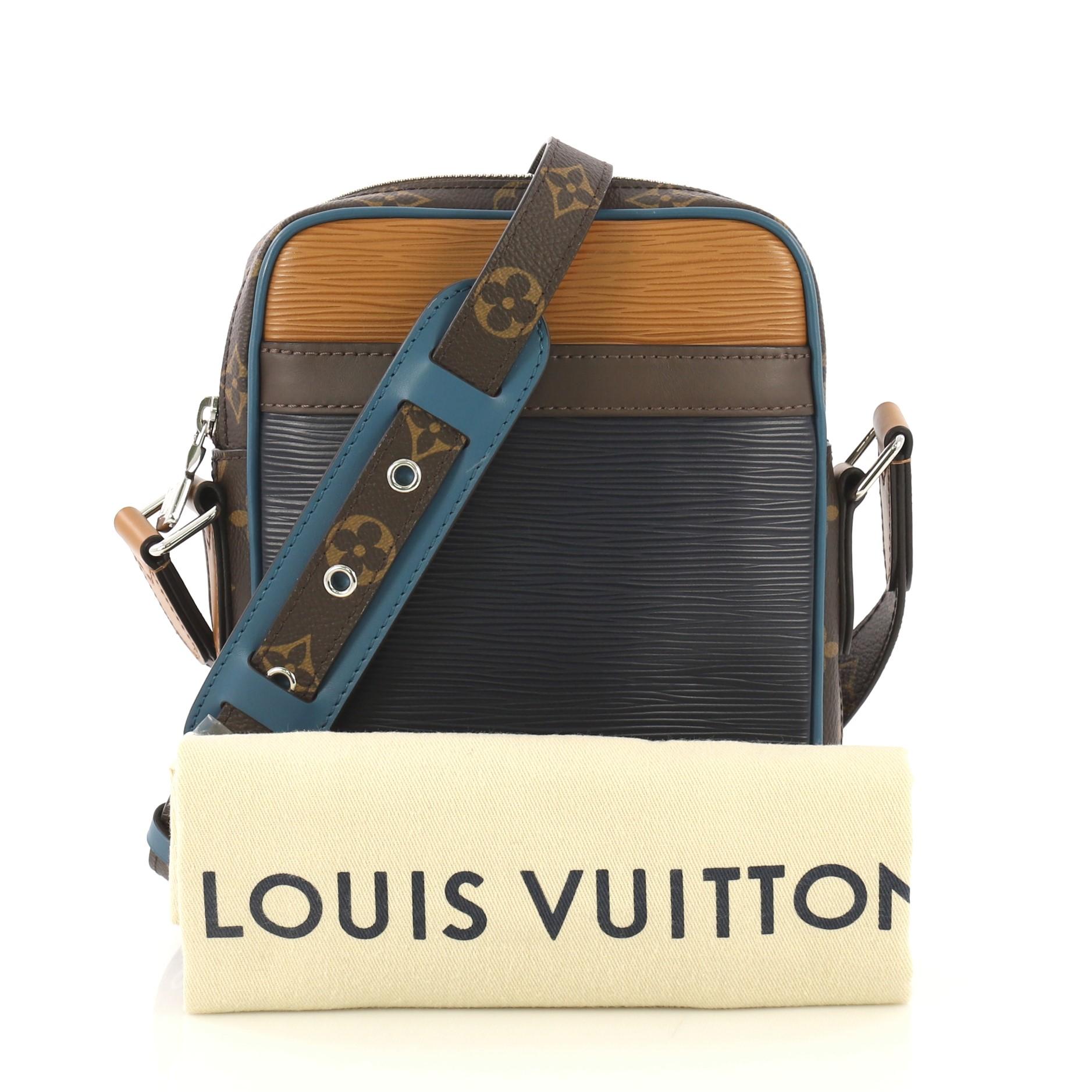 This Louis Vuitton Danube Handbag Epi Leather with Monogram Canvas Slim, crafted from brown and blue leather with monogram coated canvas, features an adjustable strap, exterior slip pocket, and silver-tone hardware. Its zip closure opens to a brown