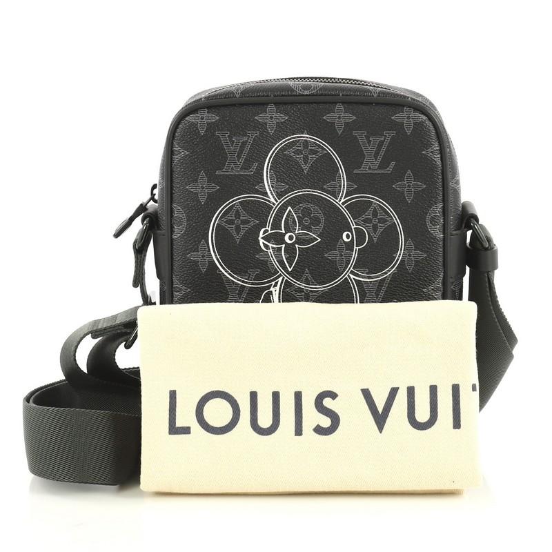 This Louis Vuitton Danube Handbag Limited Edition Vivienne Monogram Canvas PM, crafted from black monogram coated canvas, features an adjustable strap and black-tone hardware. Its zip closure opens to a green fabric interior with slip pocket.