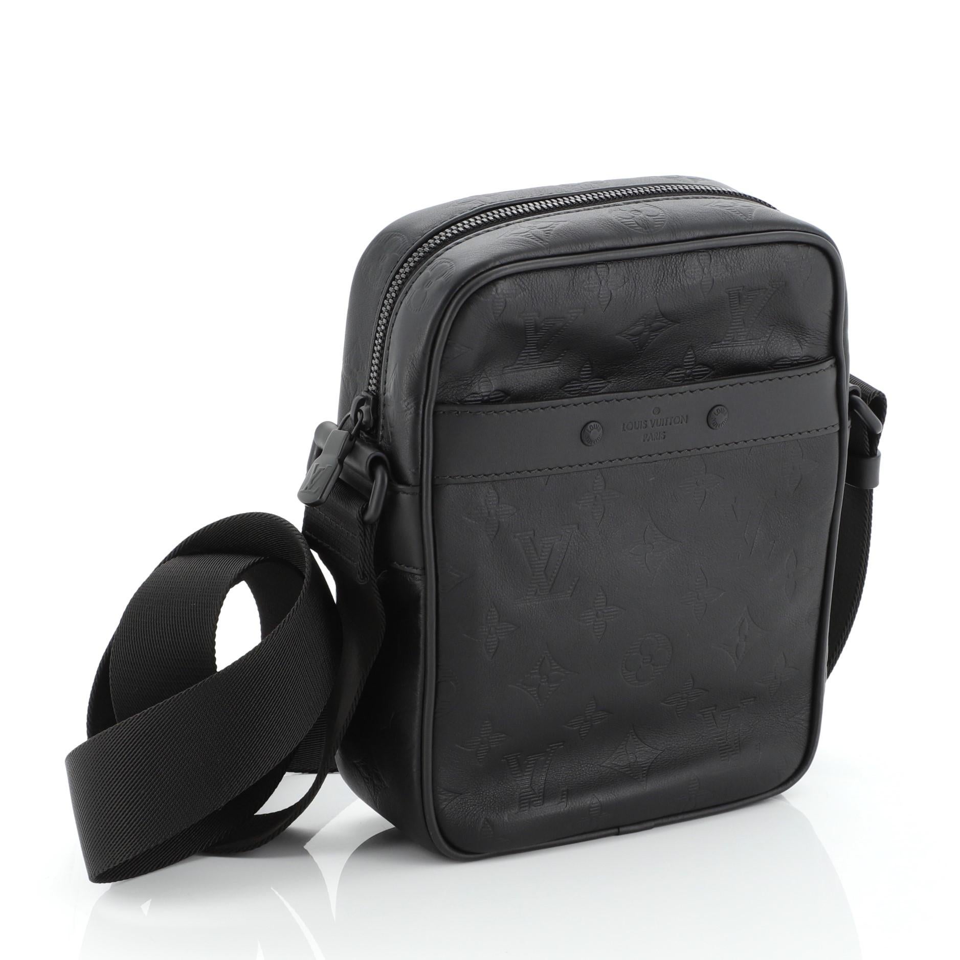 This Louis Vuitton Danube Handbag Monogram Shadow Leather PM, crafted from black monogram leather, features adjustable strap, exterior front slip pocket and black-tone hardware. Its top zip-around closure opens to a black fabric interior.
