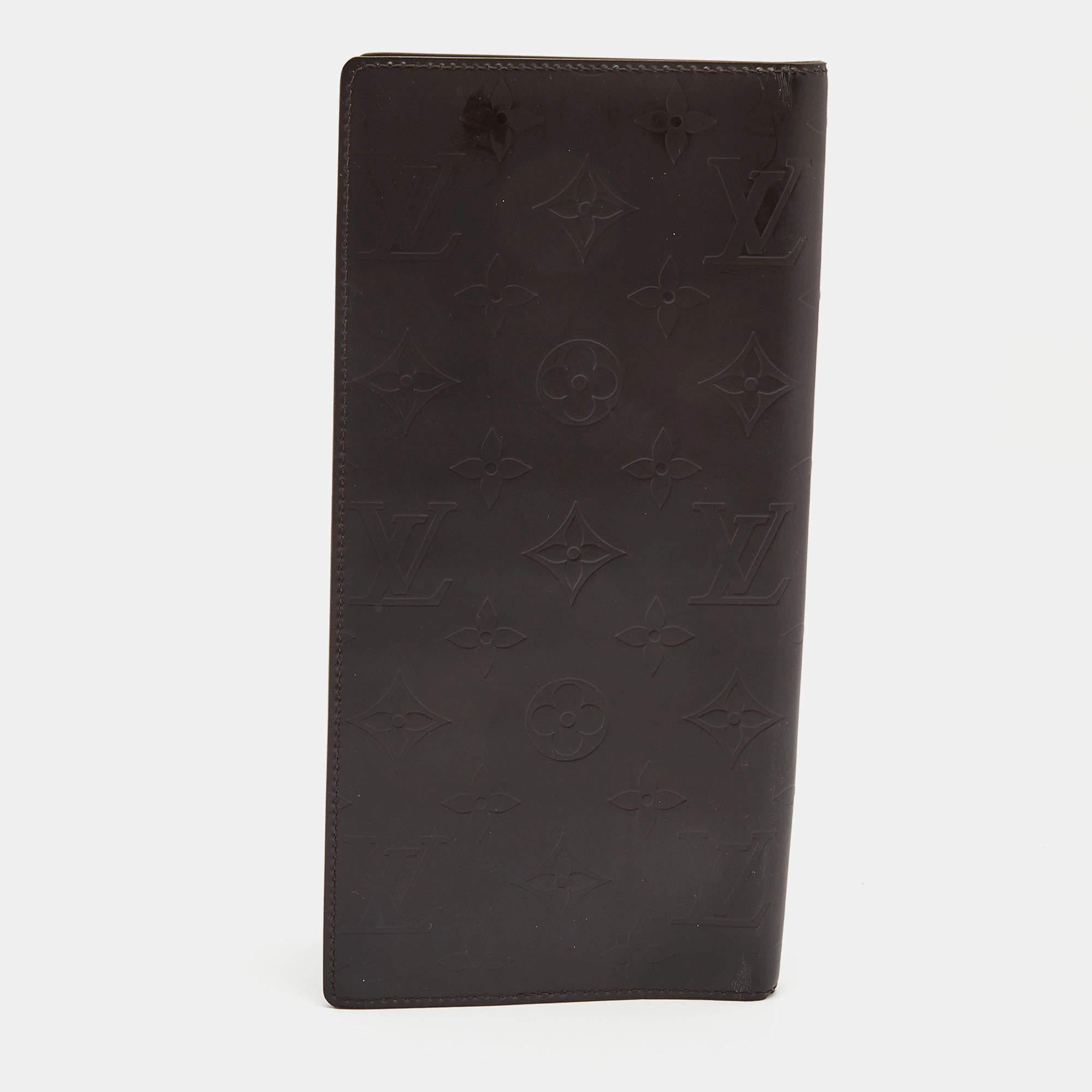 The Louis Vuitton organizer is a luxurious accessory. Crafted from dark brown monogram leather, it features a classic bifold design with multiple card slots, a bill compartment, and an organized interior, making it a stylish and functional essential